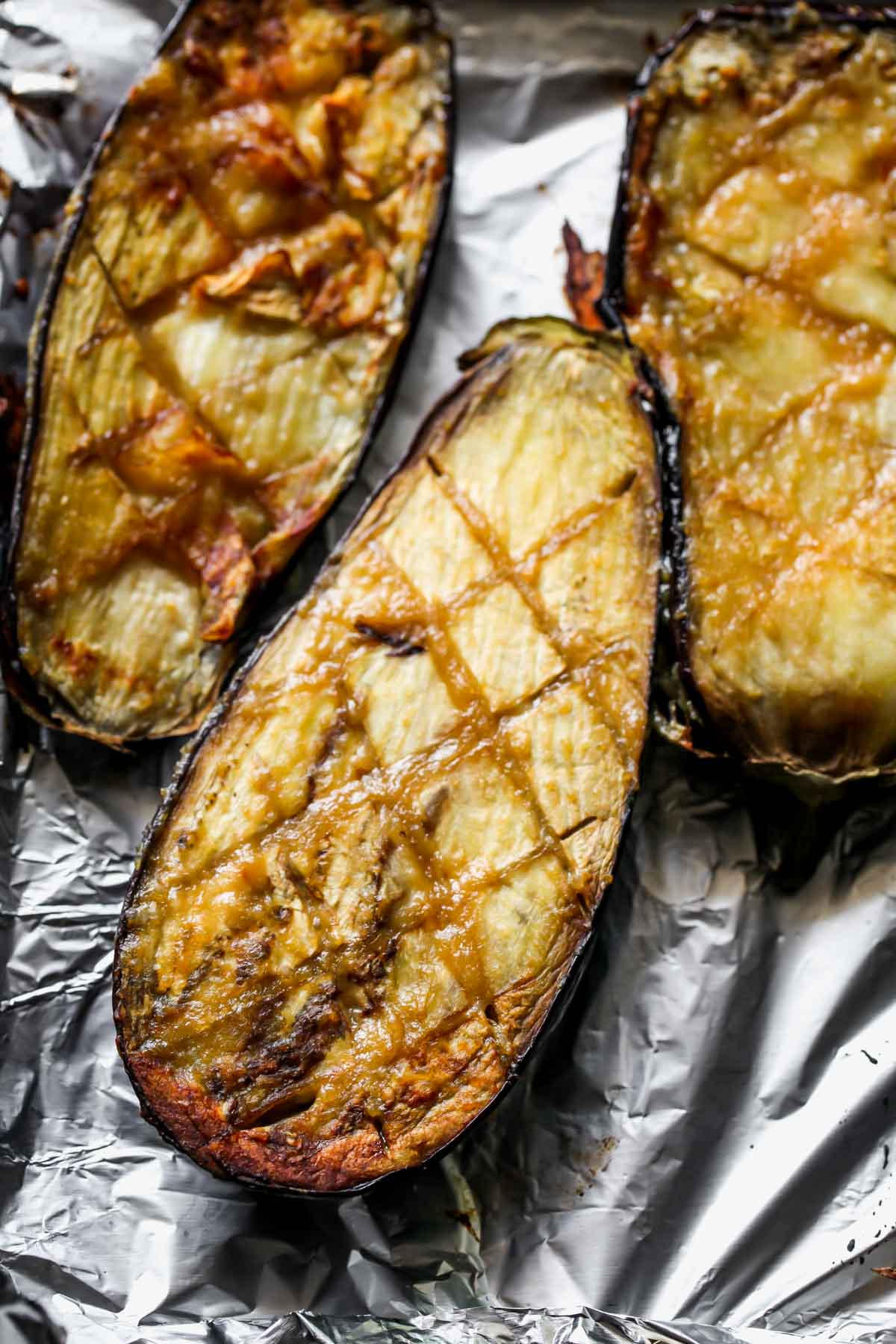 Miso roasted eggplant halves on a baking sheet