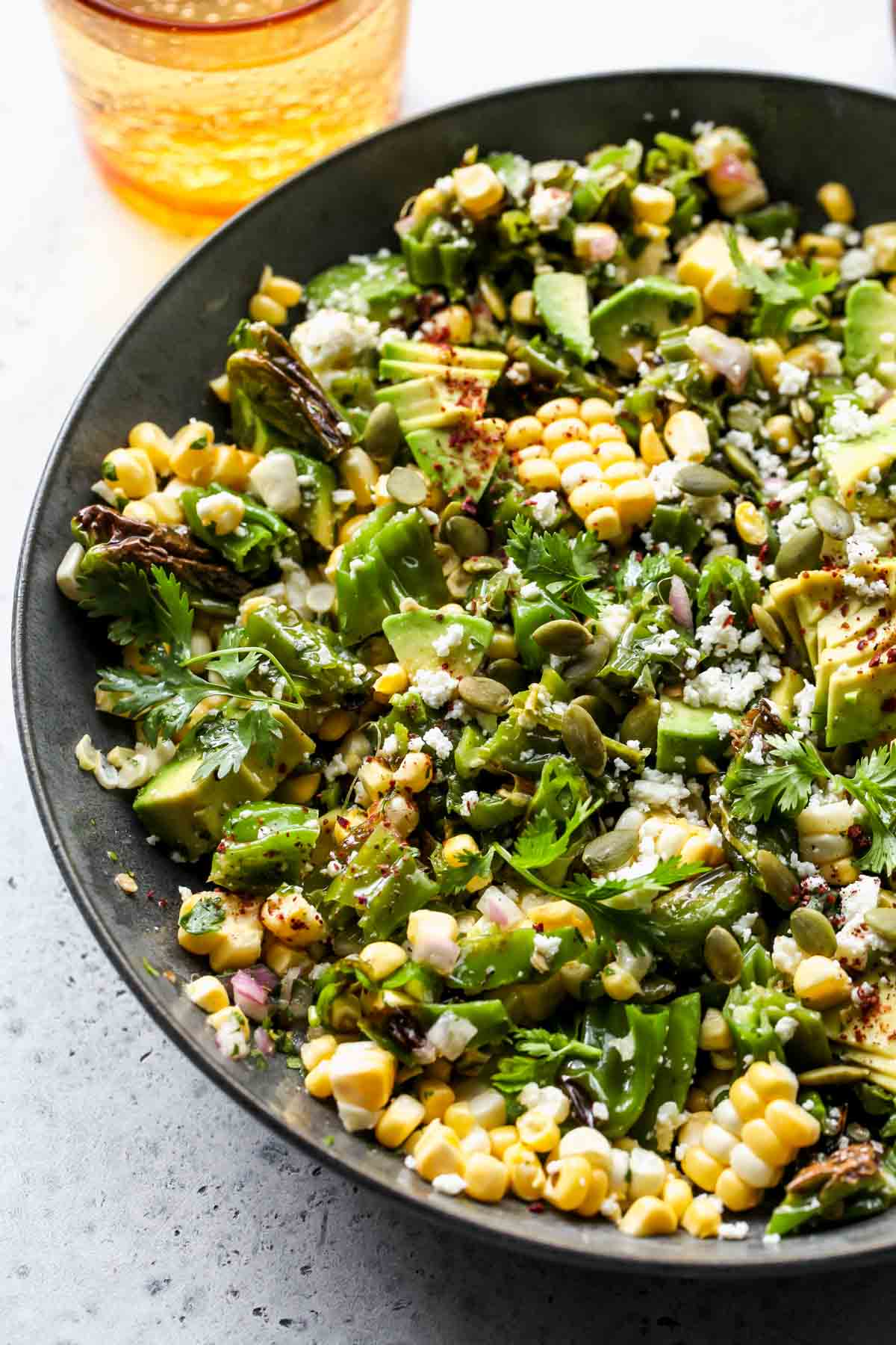 Shishito and corn salad styled in a serving bowl