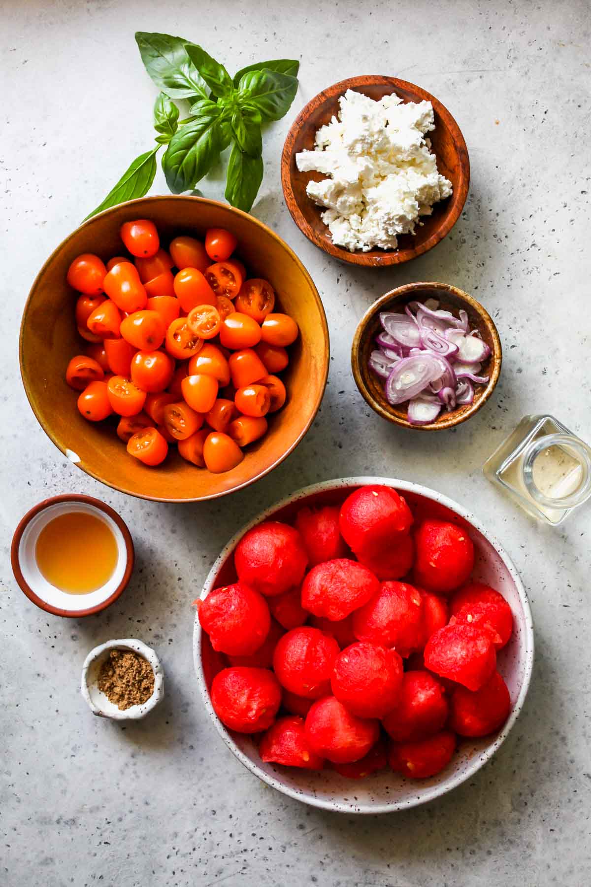Recipe ingredients in separate bowls on a gray work surface