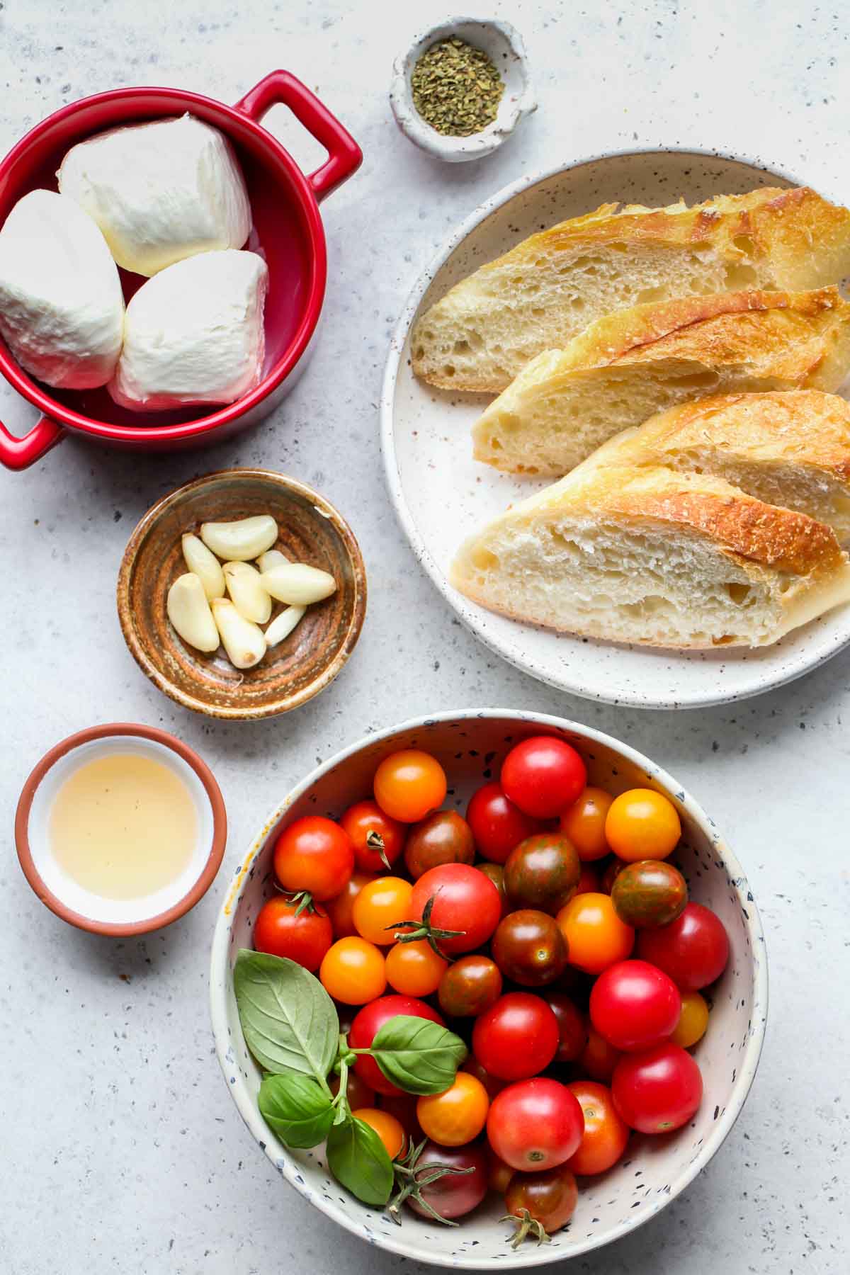 Recipe ingredients in separate bowls on a gray work surface