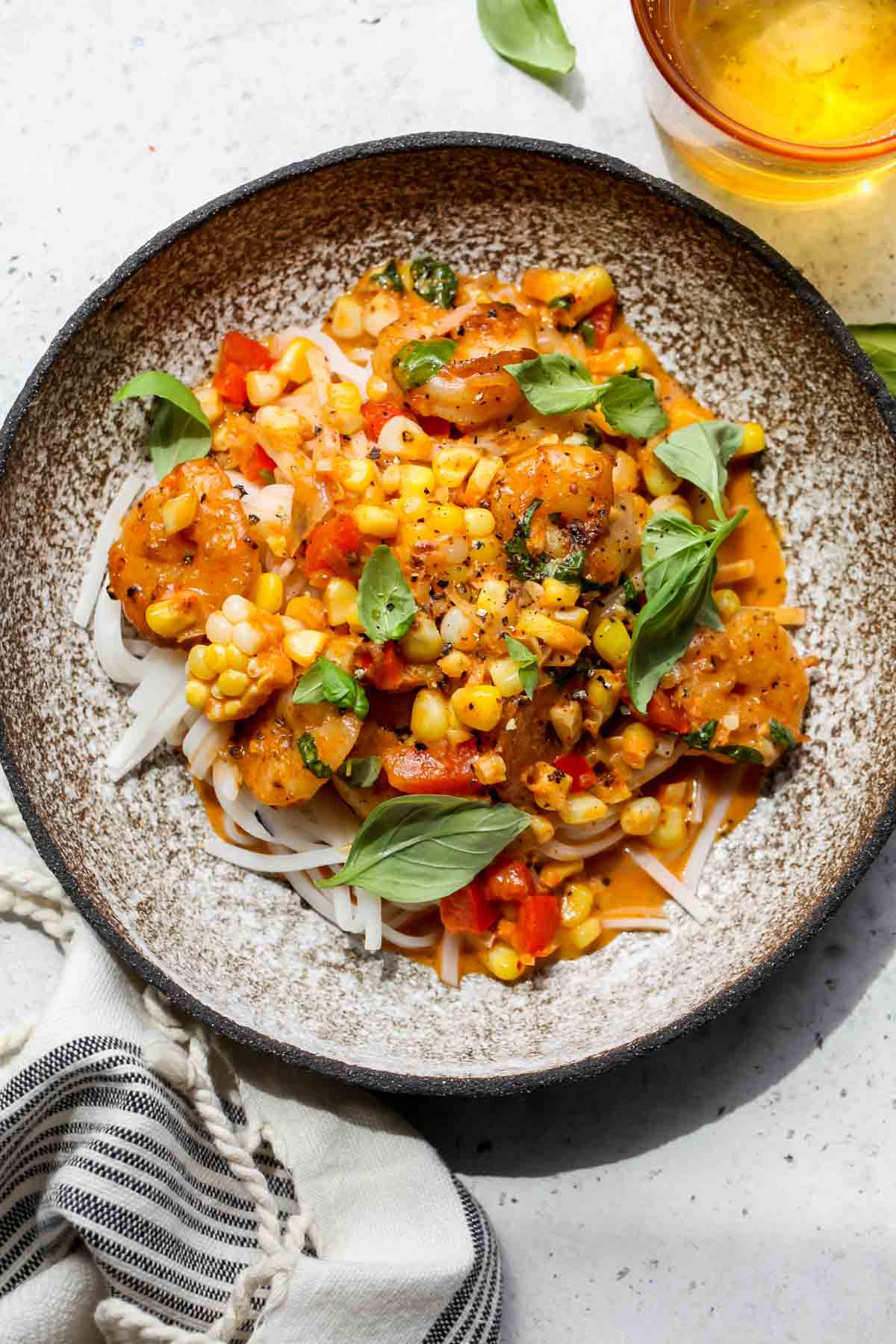 A plate of rice noodles topped with creamy coconut shrimp