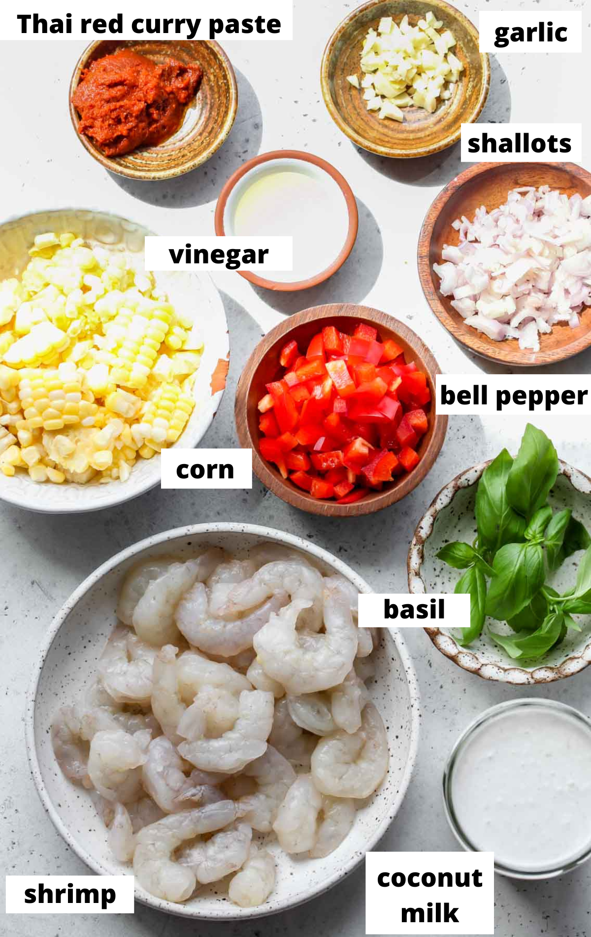 Recipe ingredients in separate bowls with black and white labels