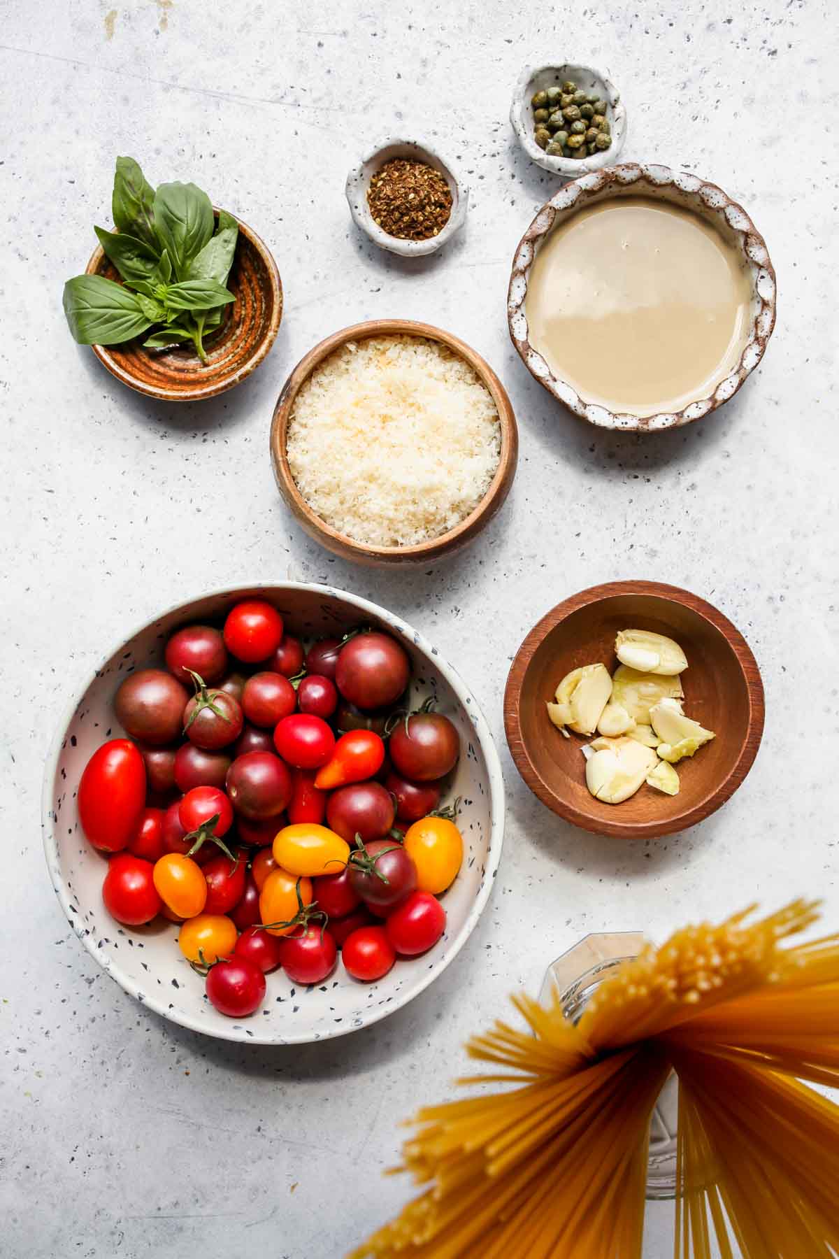 Recipe ingredients in separate bowls on a gray work surface.
