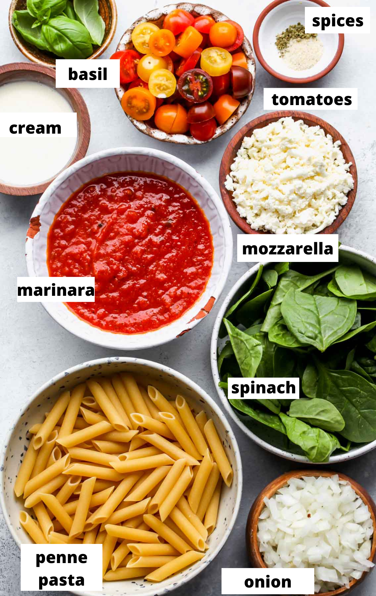 Recipe ingredients in separate bowls on a blue board with labels