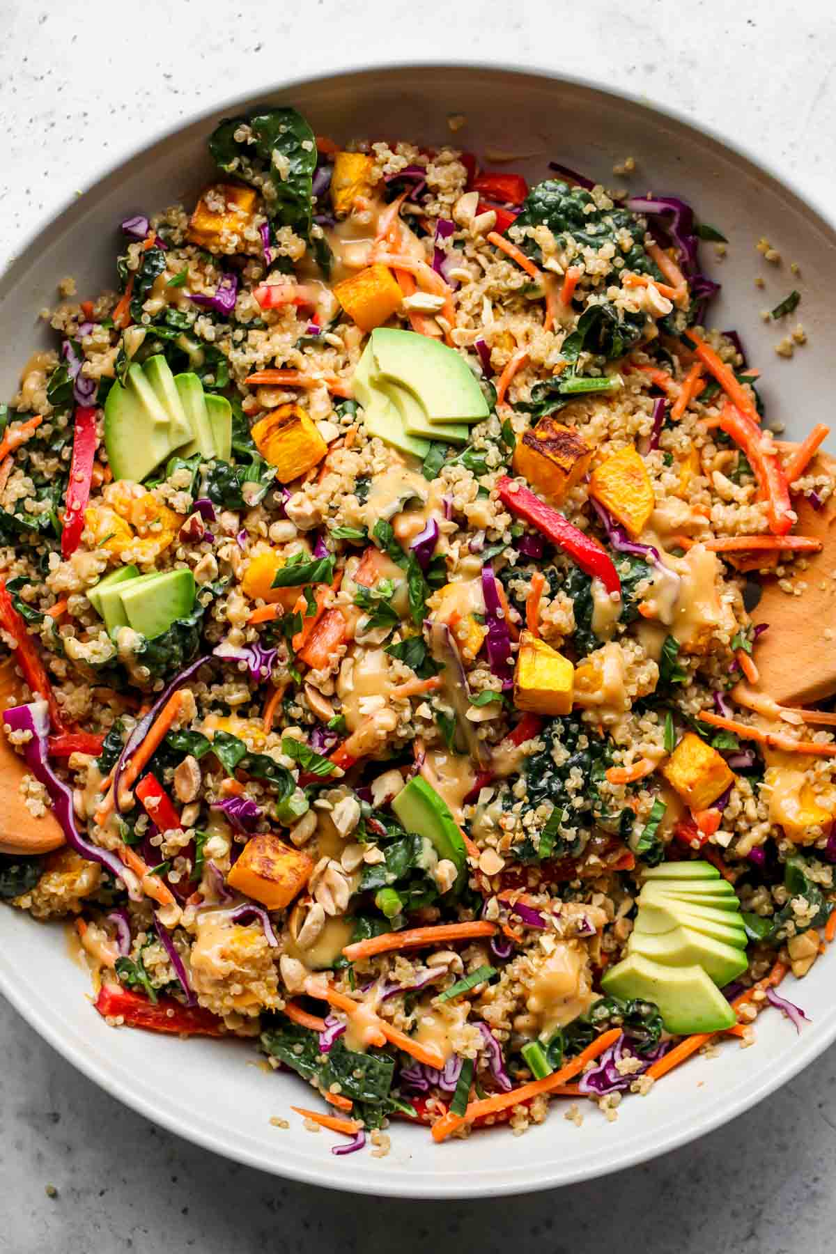 Thai quinoa salad with roasted squash and avocado in a serving bowl