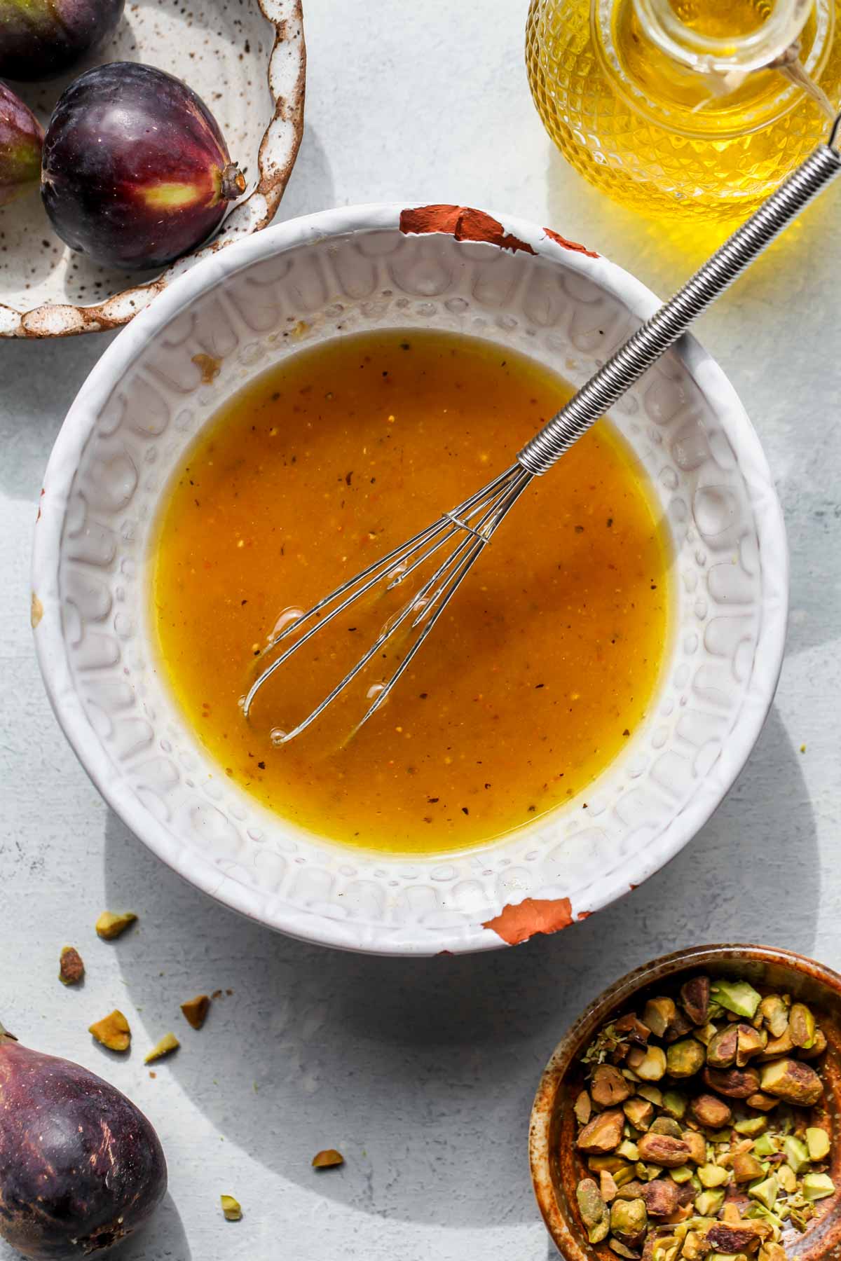 Fig vinaigrette being whisked in a white bowl
