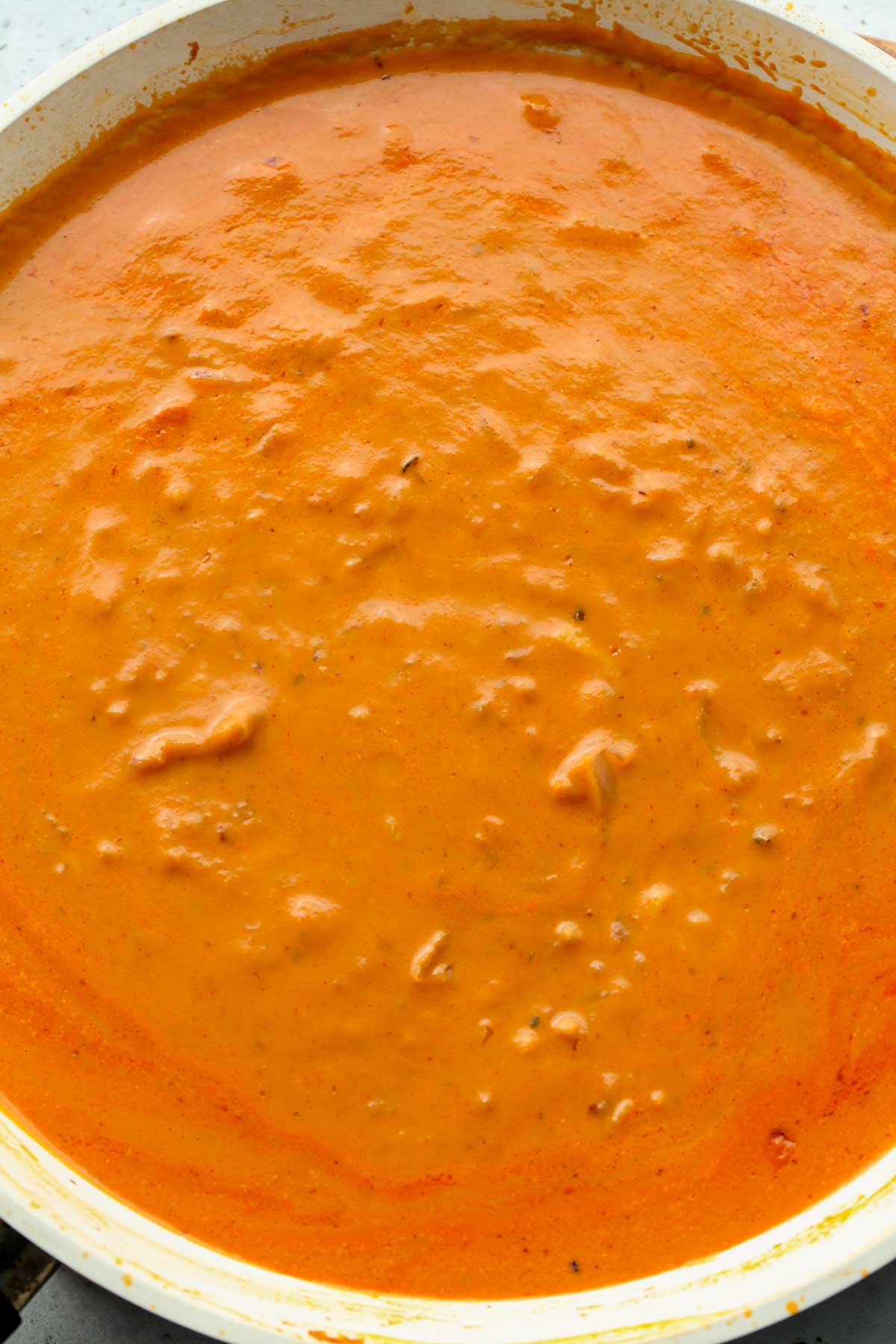Pumpkin pasta sauce simmering in a skillet