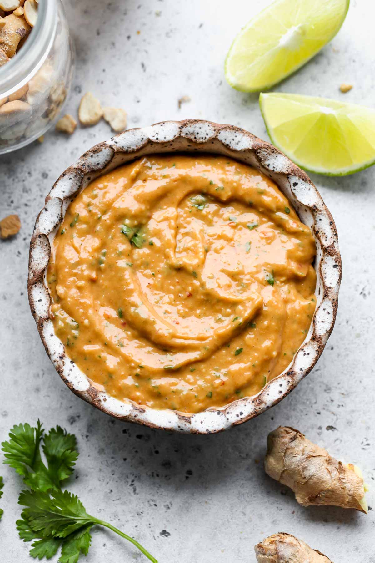 Spicy cashew dressing in a small white scalloped bowl