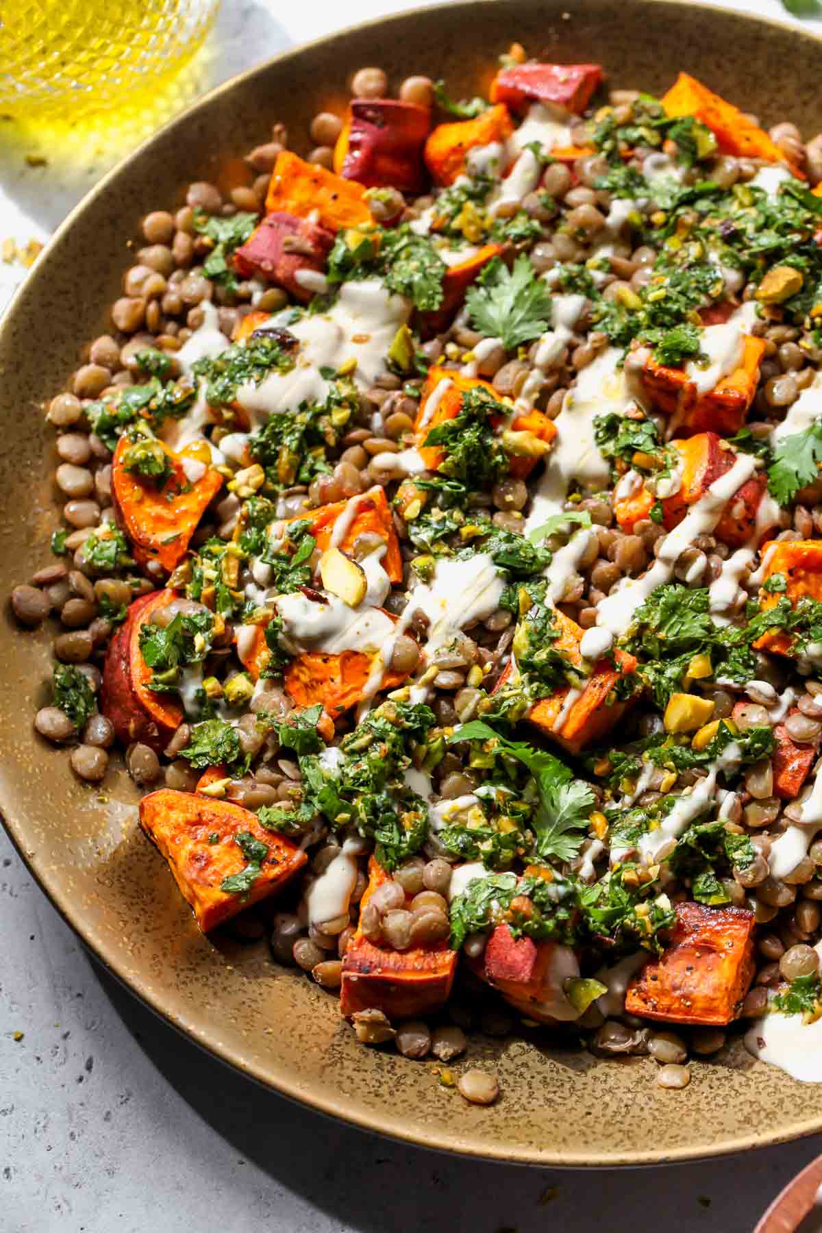 Sweet potato lentil salad topped with pistachio salsa and tahini-lime drizzle