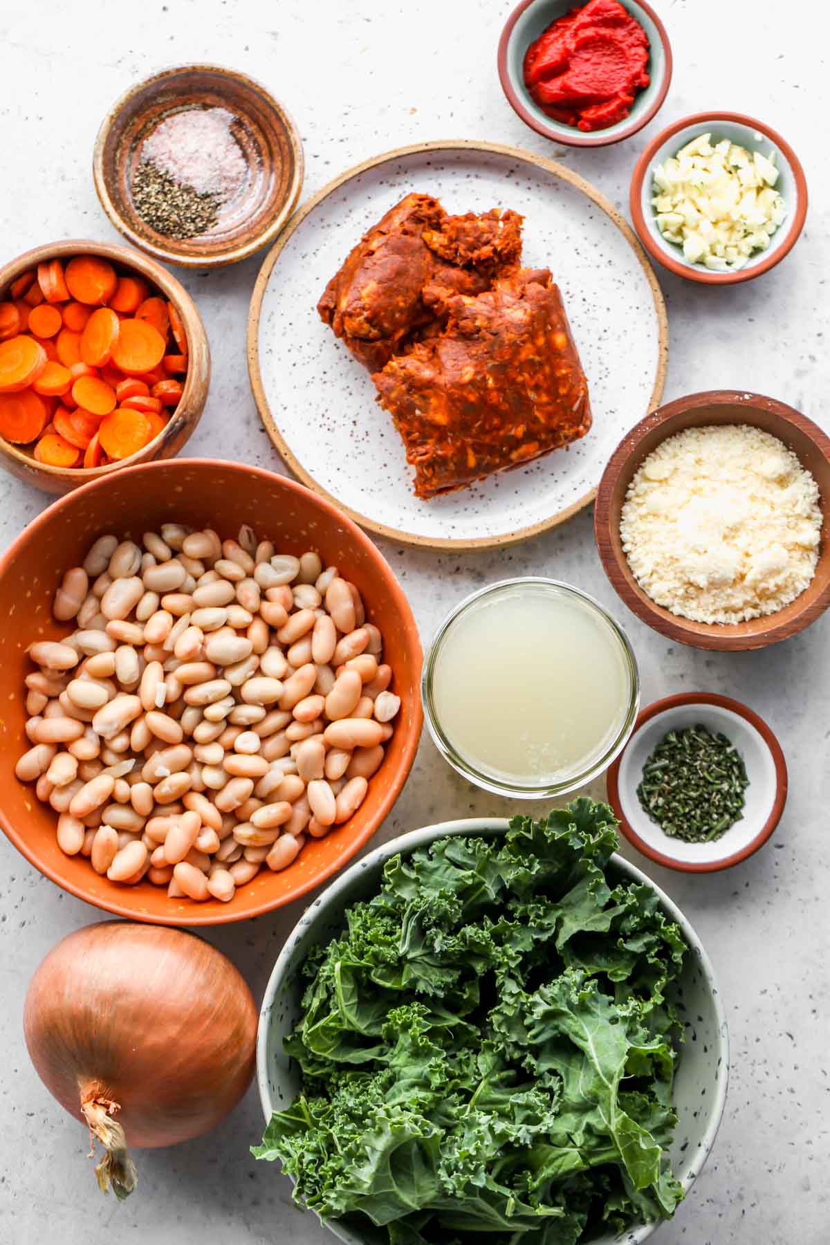 Recipe ingredients in separate bowls on a grey surface