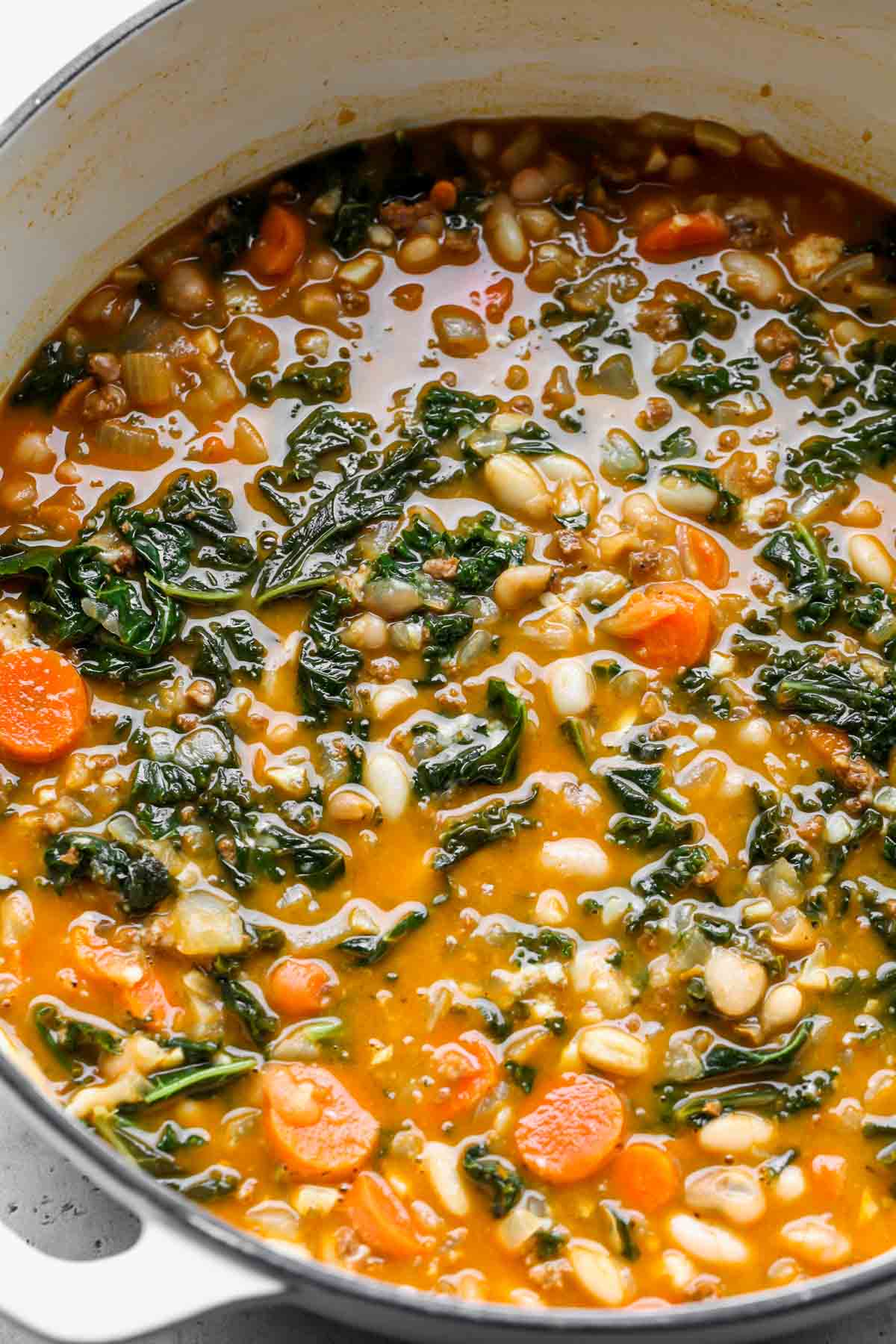 White dutch oven filled with soup after being simmered