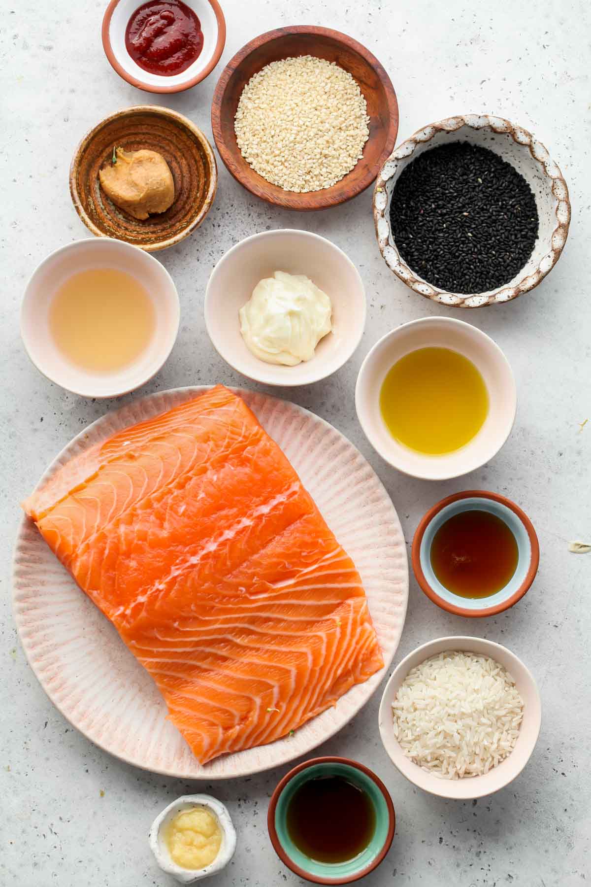 Recipe ingredients in separate bowls on a grey surface
