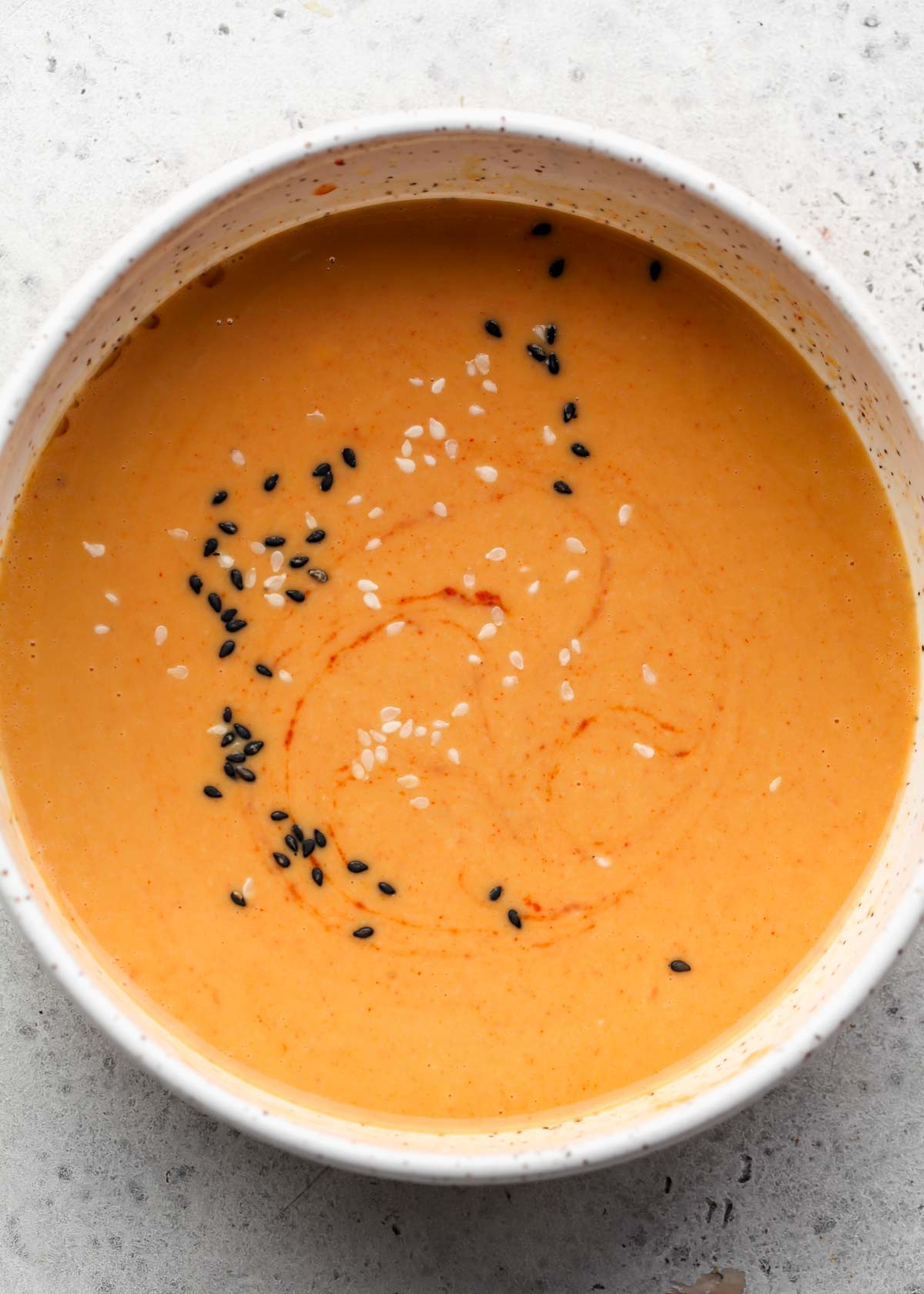 Miso-ginger sauce mixed in a white speckled bowl