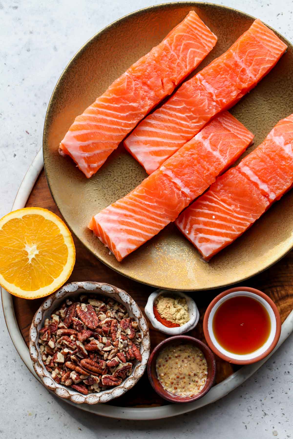 Recipe ingredients in separate bowls arranged on a wooden serving tray