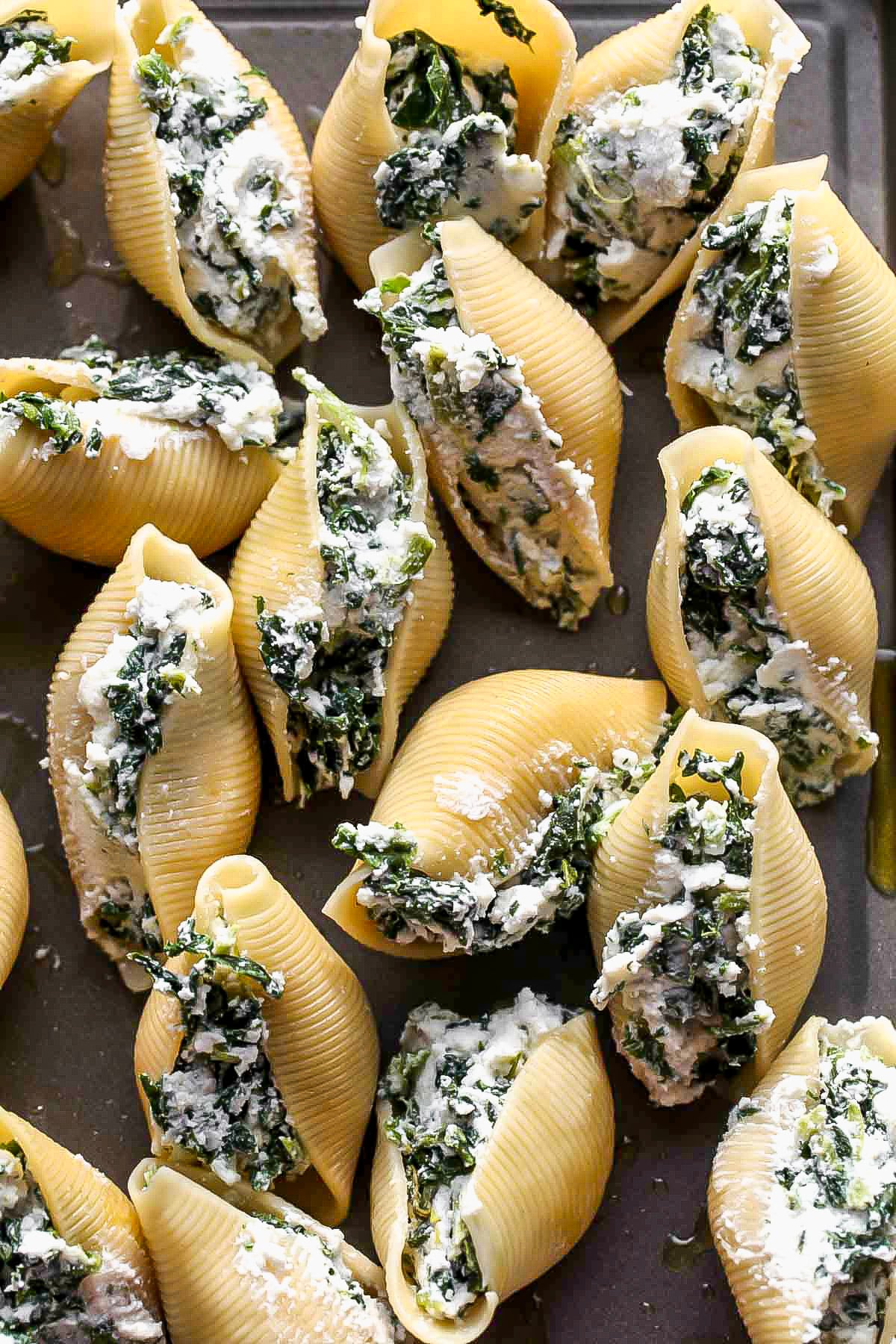 Shells being stuffed with ricotta and spinach mixture