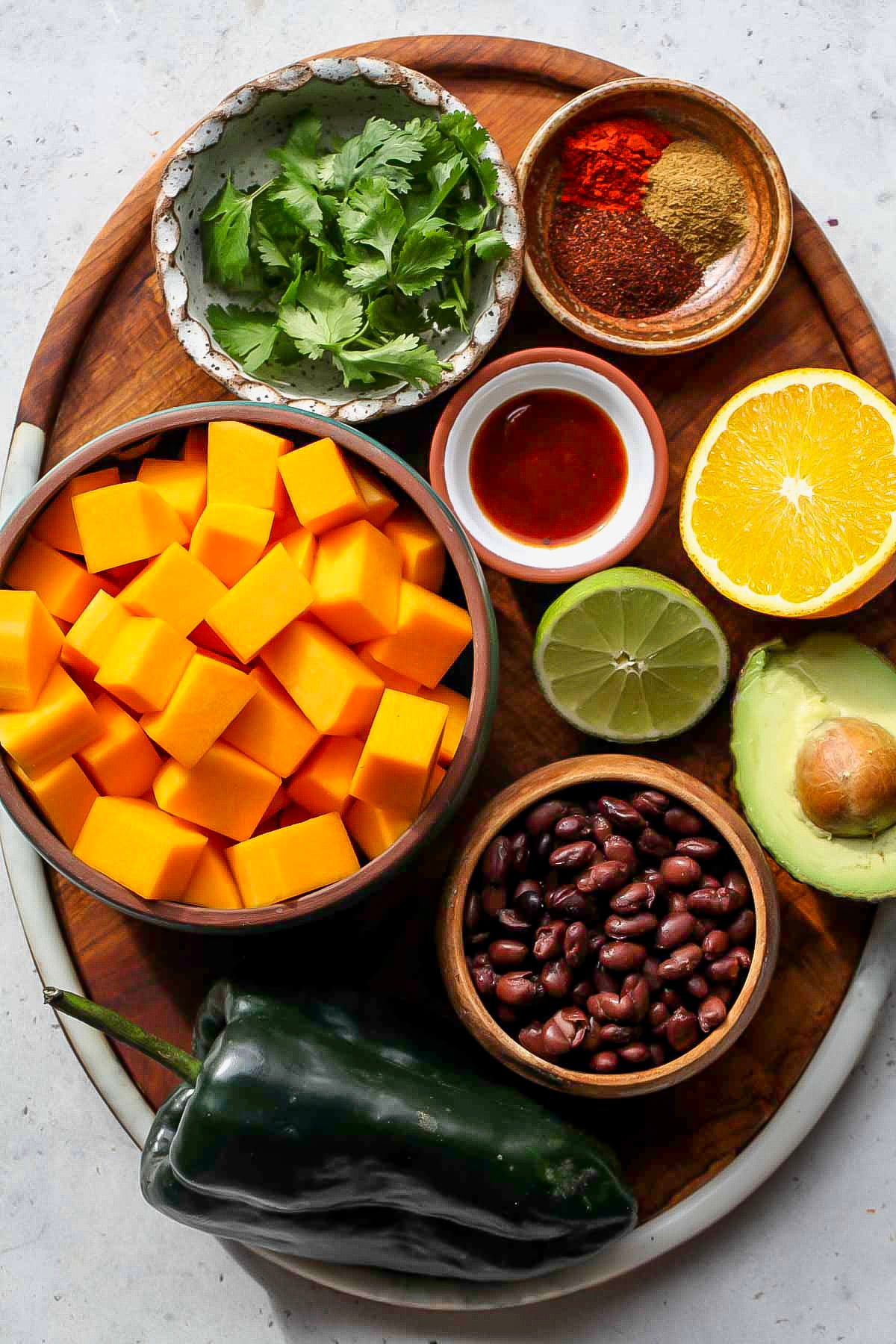 Recipe ingredients arranged on a wooden serving platter.