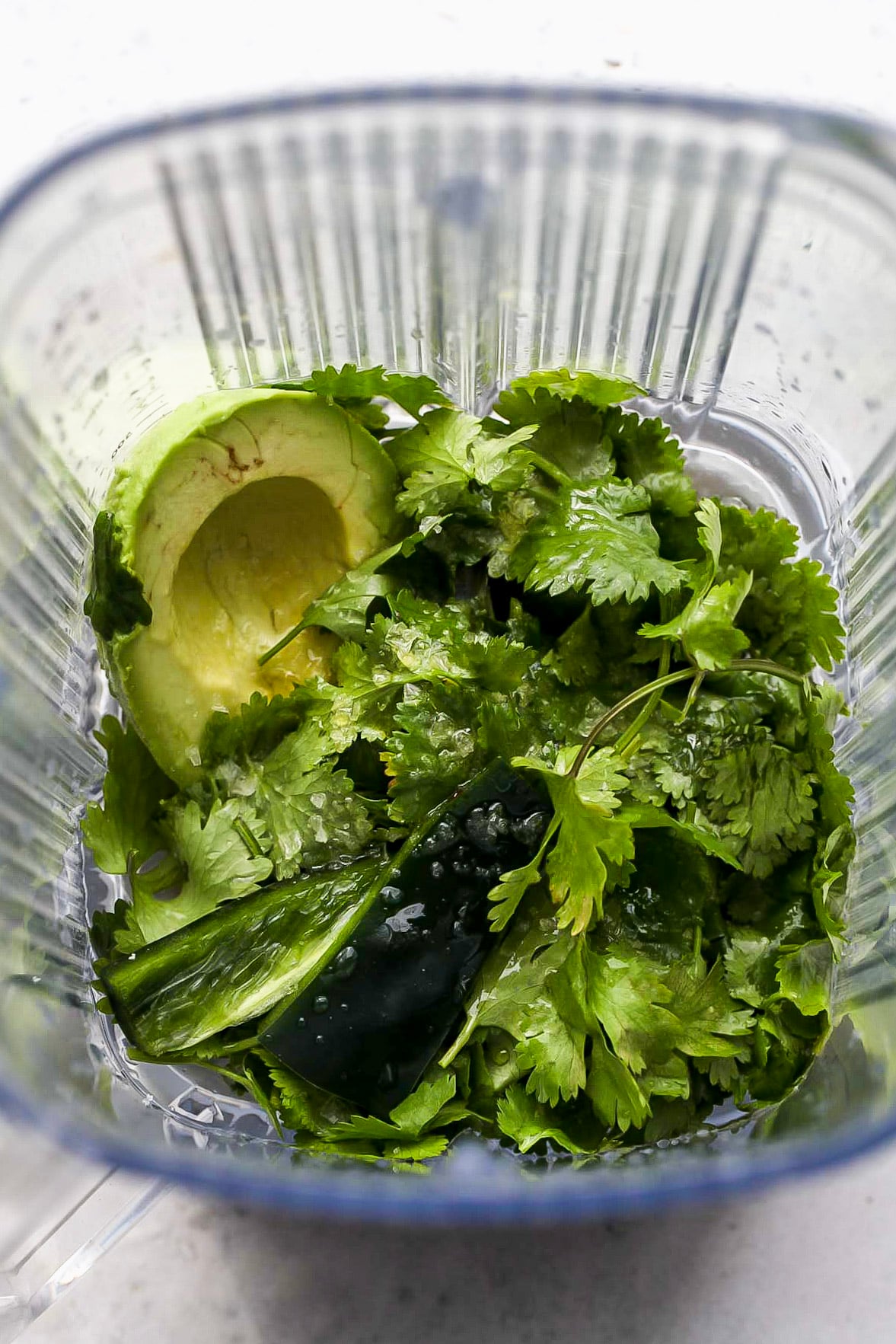 Avocado, cilantro, citrus juice, and olive oil in a blender.