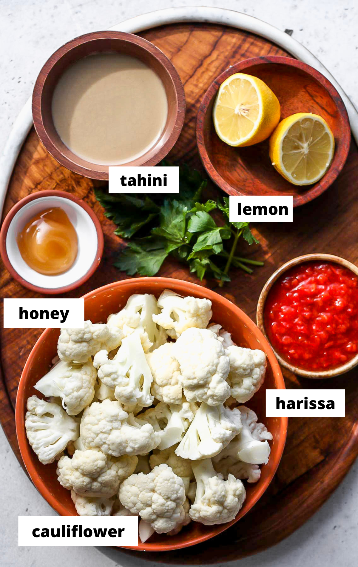 Recipe ingredients with labels arranged on a wooden serving platter