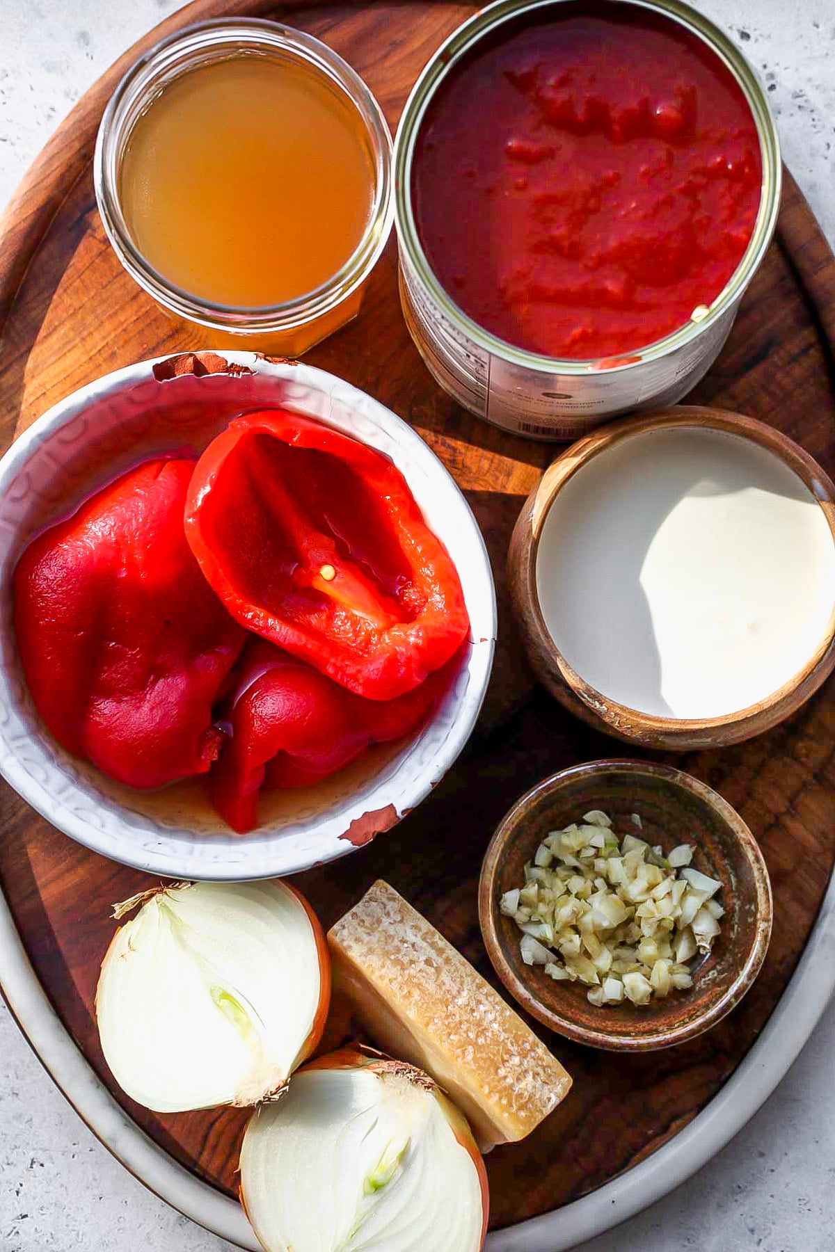 Recipe ingredients in bowls arranged on a wooden serving platter