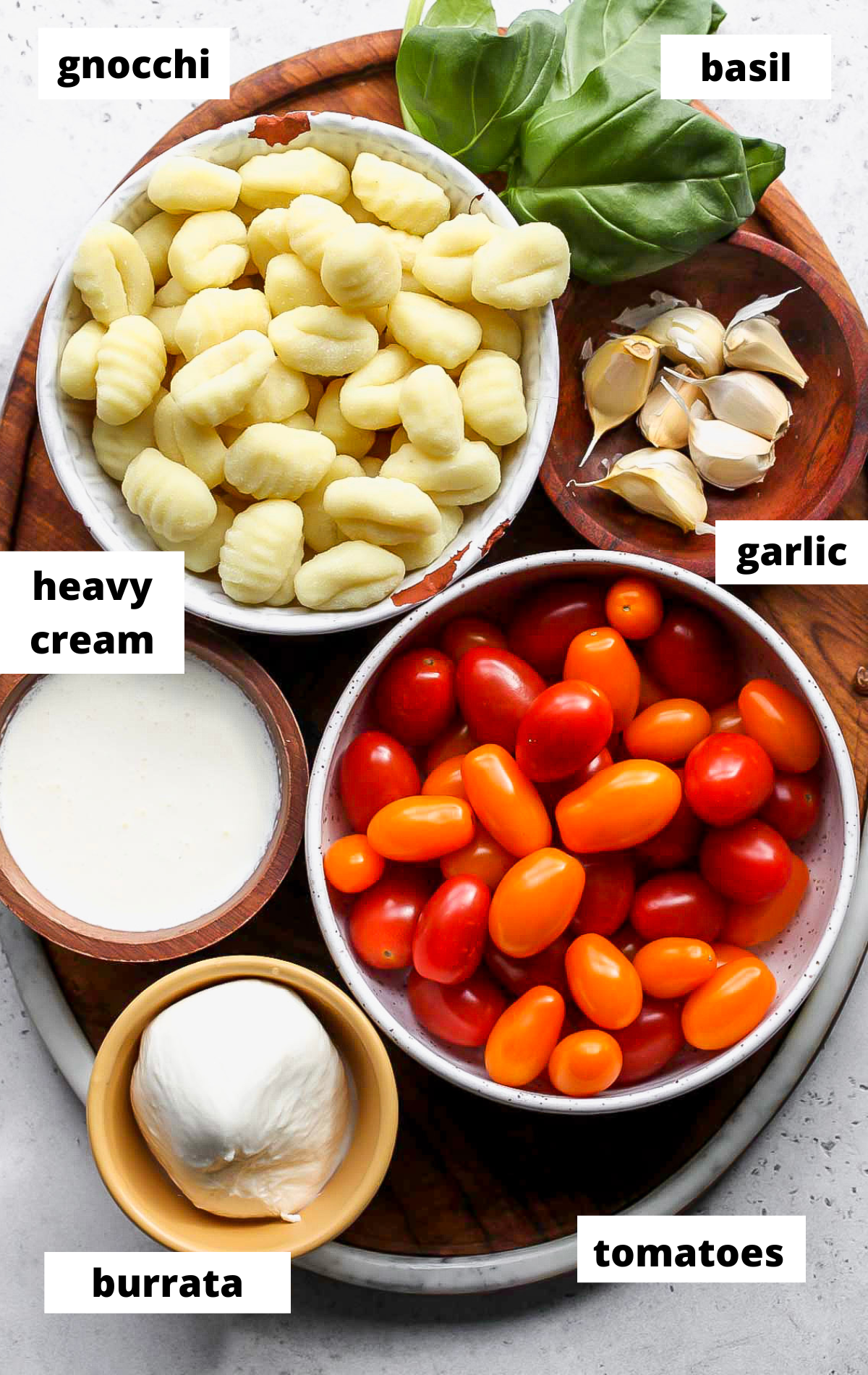 Recipe ingredients with labels arranged on a wooden serving platter.