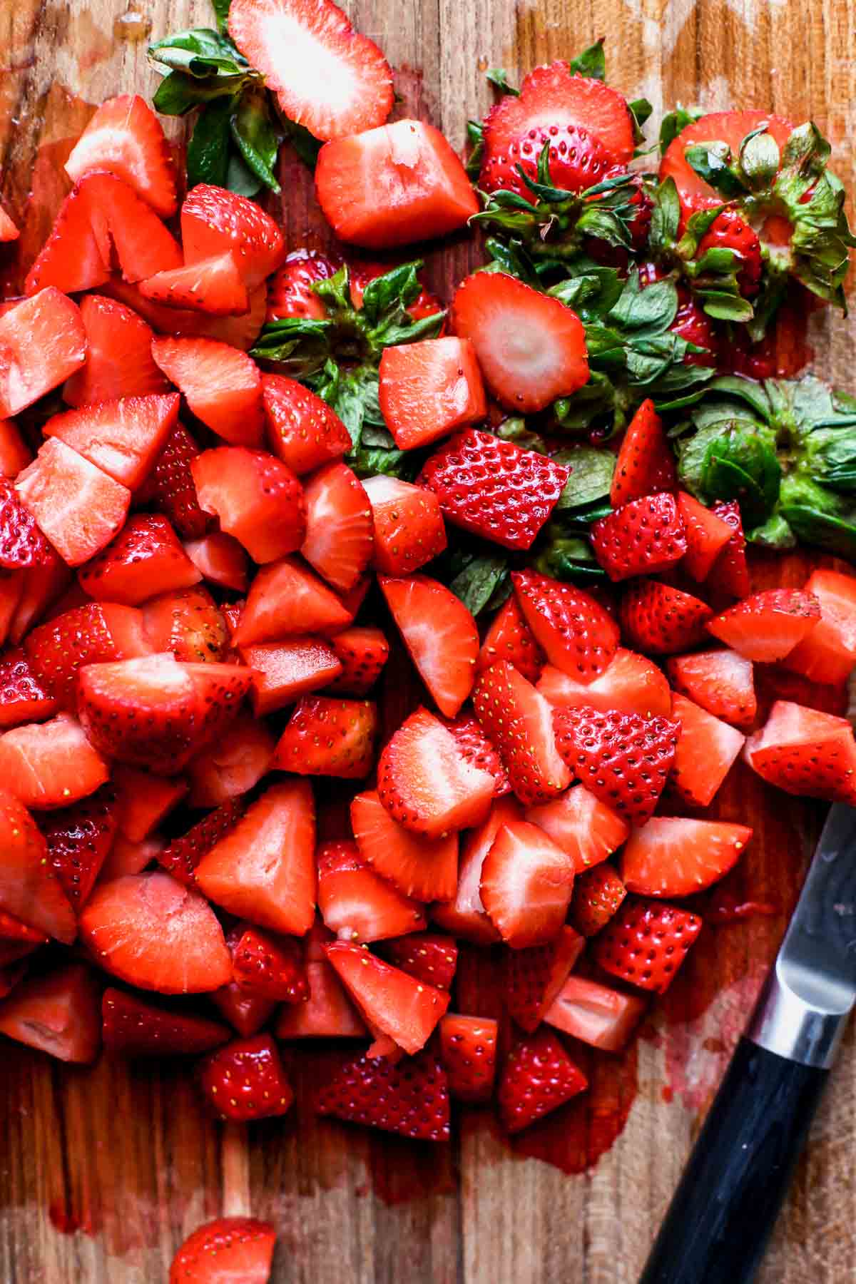Strawberries being hulled and diced.