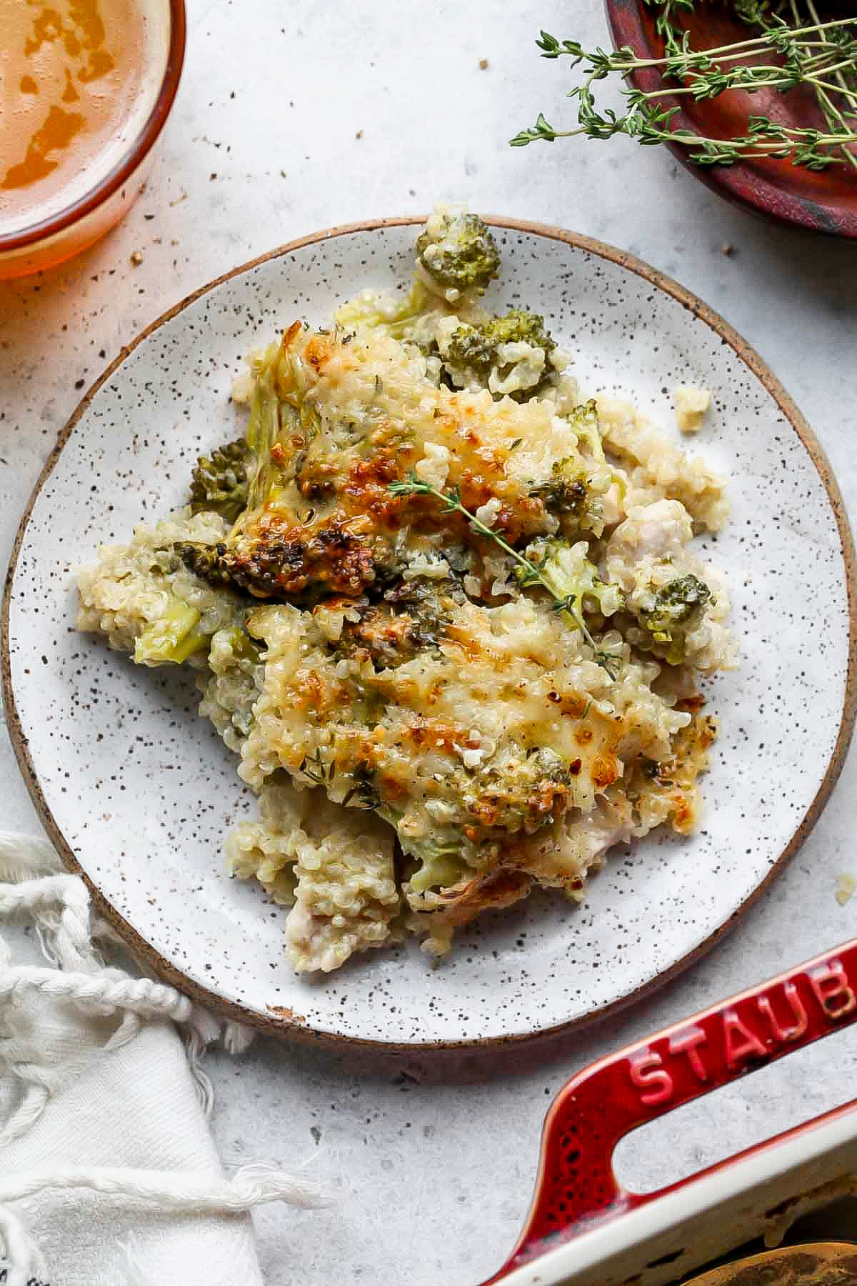 A small white serving plate filled with chicken broccoli bake.