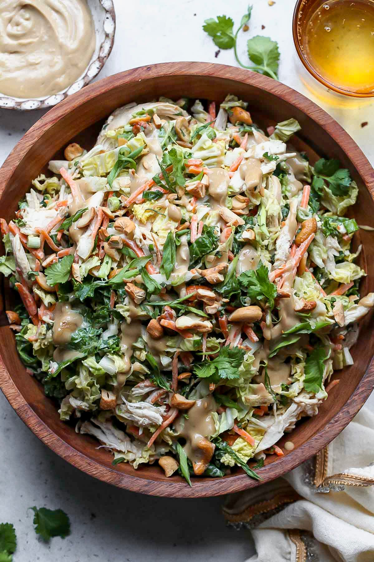 Chicken cashew crunch salad in a large wooden serving bowl.