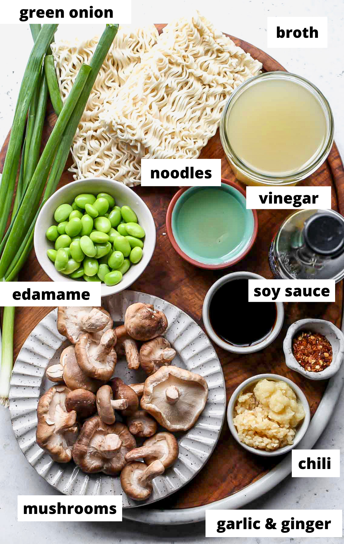 Recipe ingredients with labels arranged on a wooden serving board.