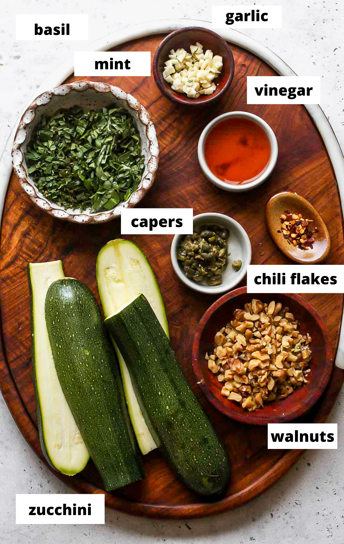 Recipe ingredients arranged on a wooden serving platter with labels.