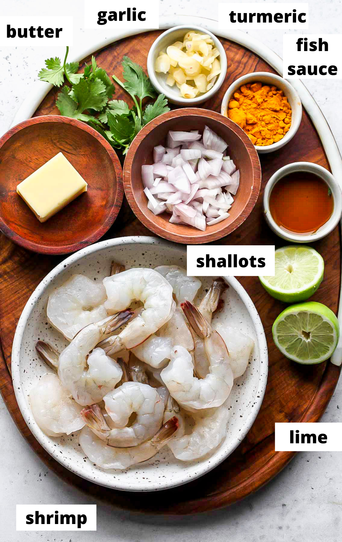 Recipe ingredients arranged on a wooden platter with labels.