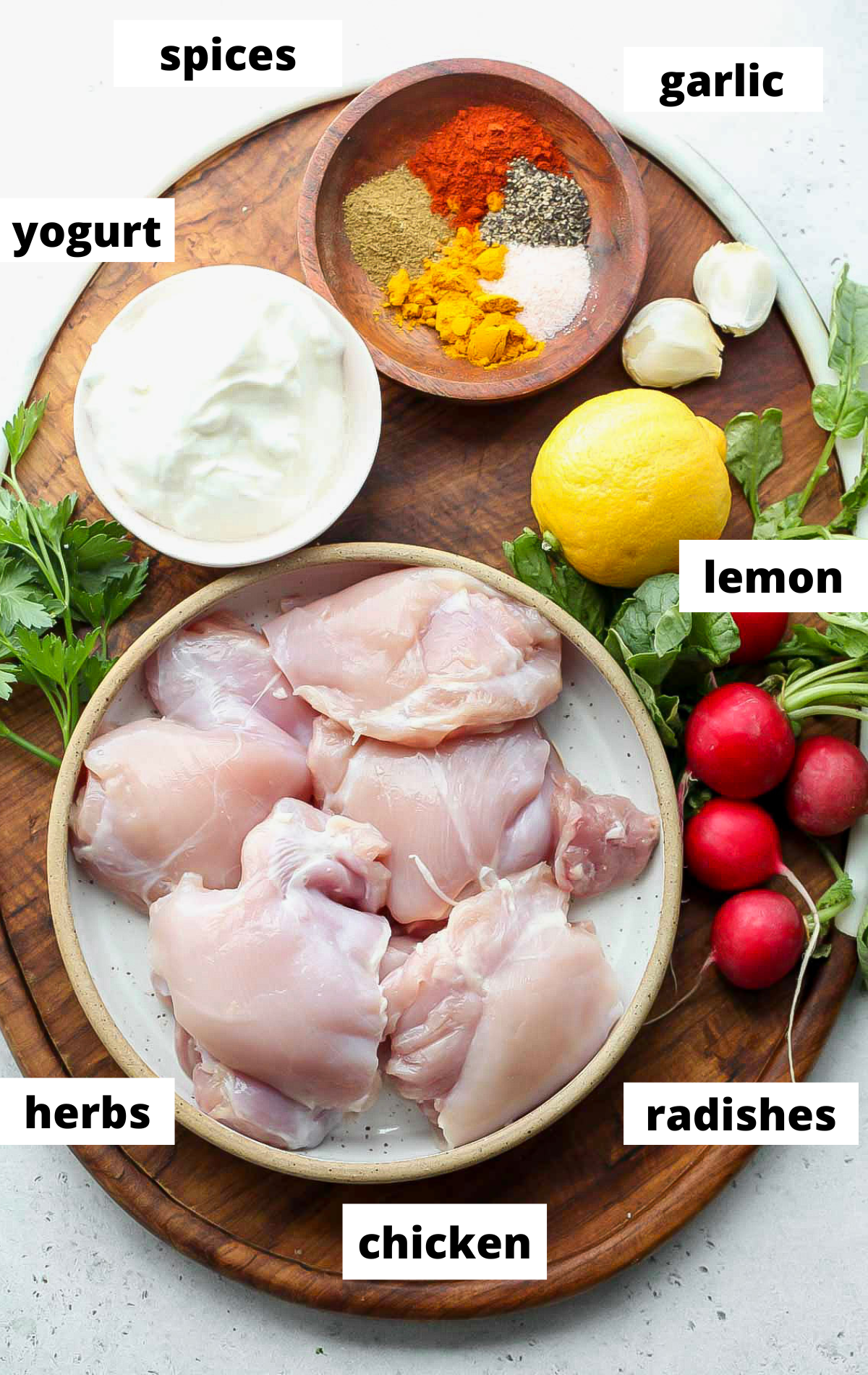 Recipe ingredients arranged in bowls on a wooden serving platter with labels.