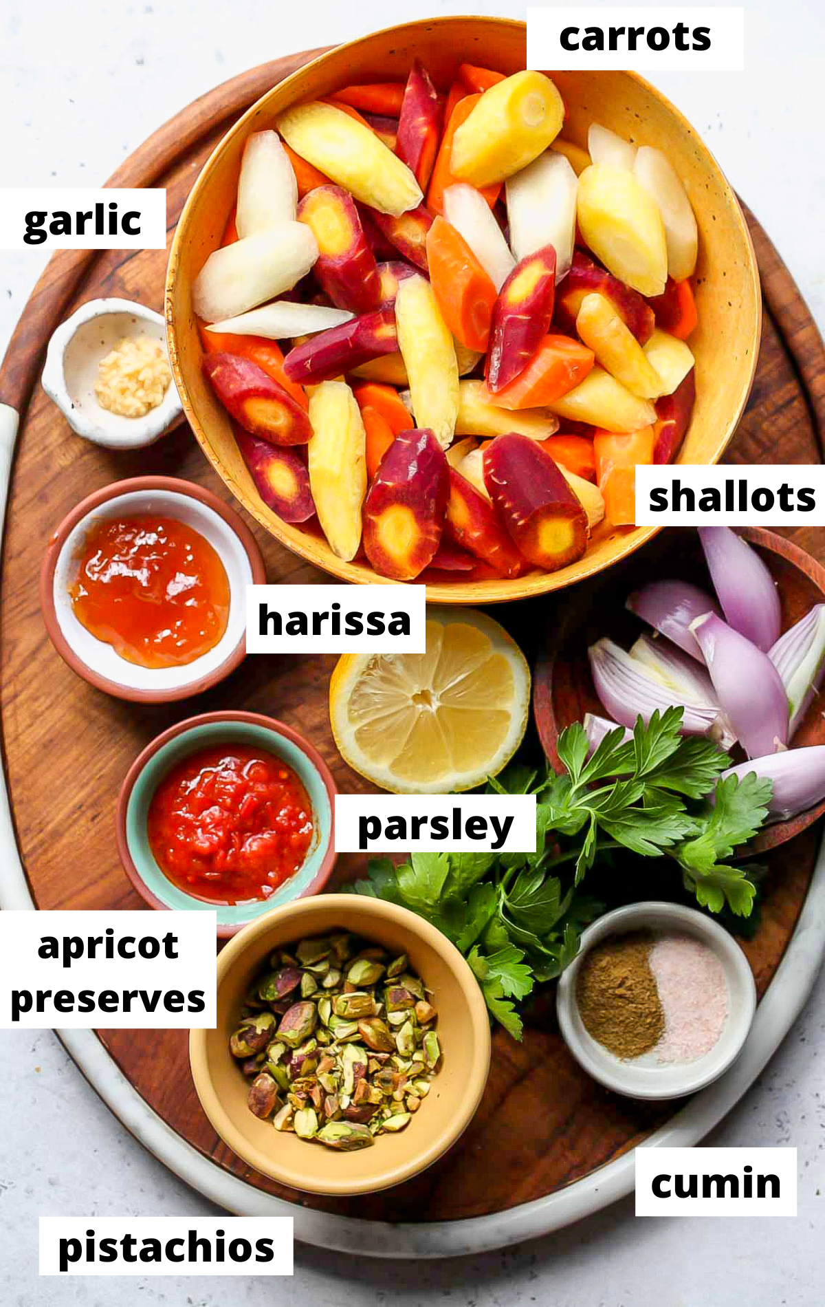 Recipe ingredients arranged on a wooden platter with labels.