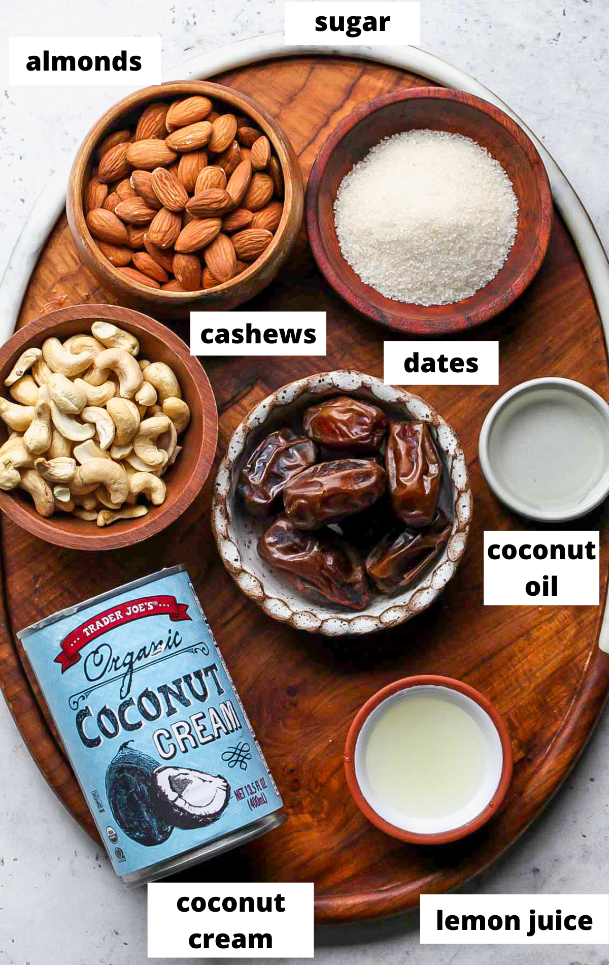 Recipe ingredients in separate bowls on a wooden board with labels.