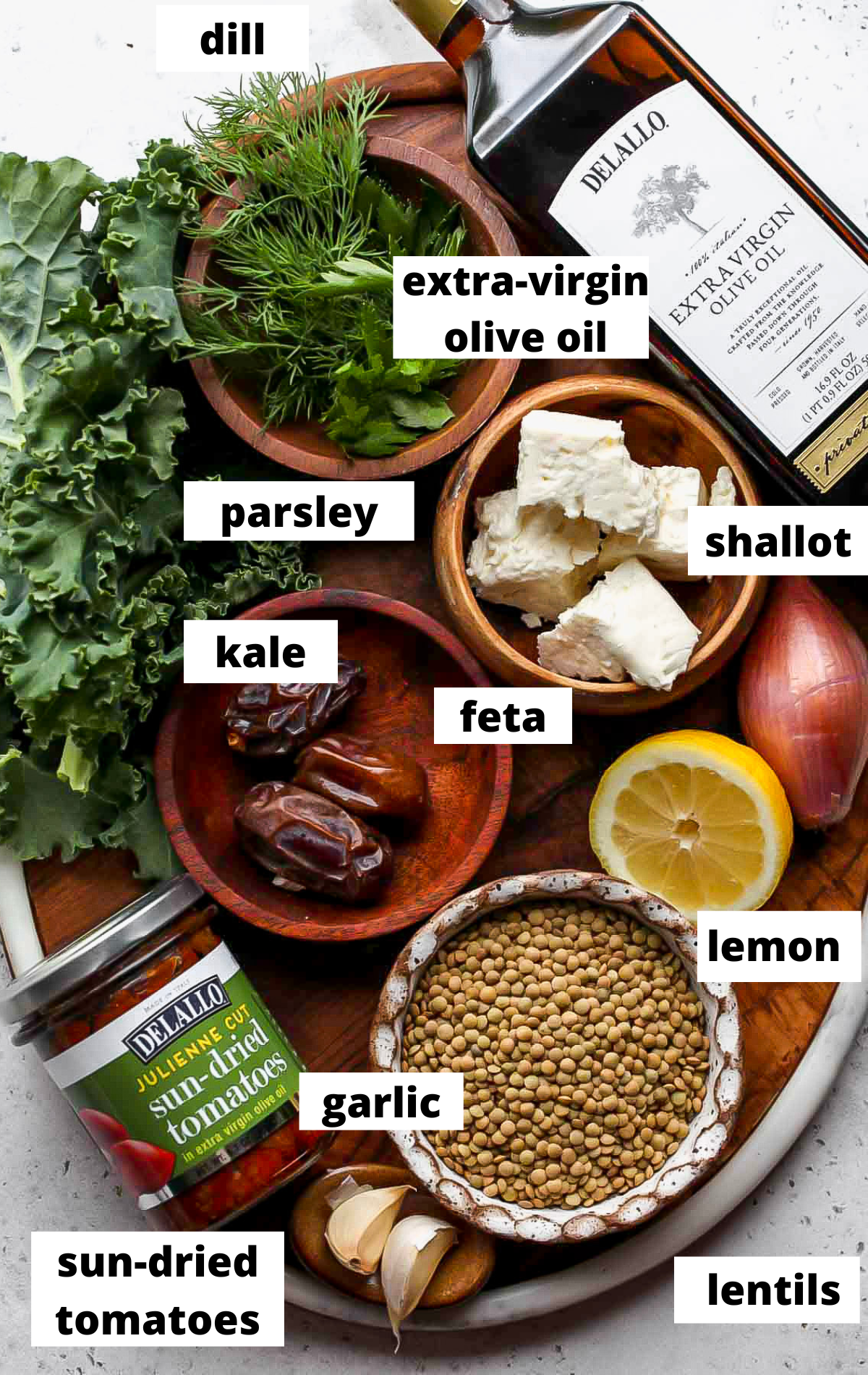 Recipe ingredients in separate bowls with labels on a wooden platter.