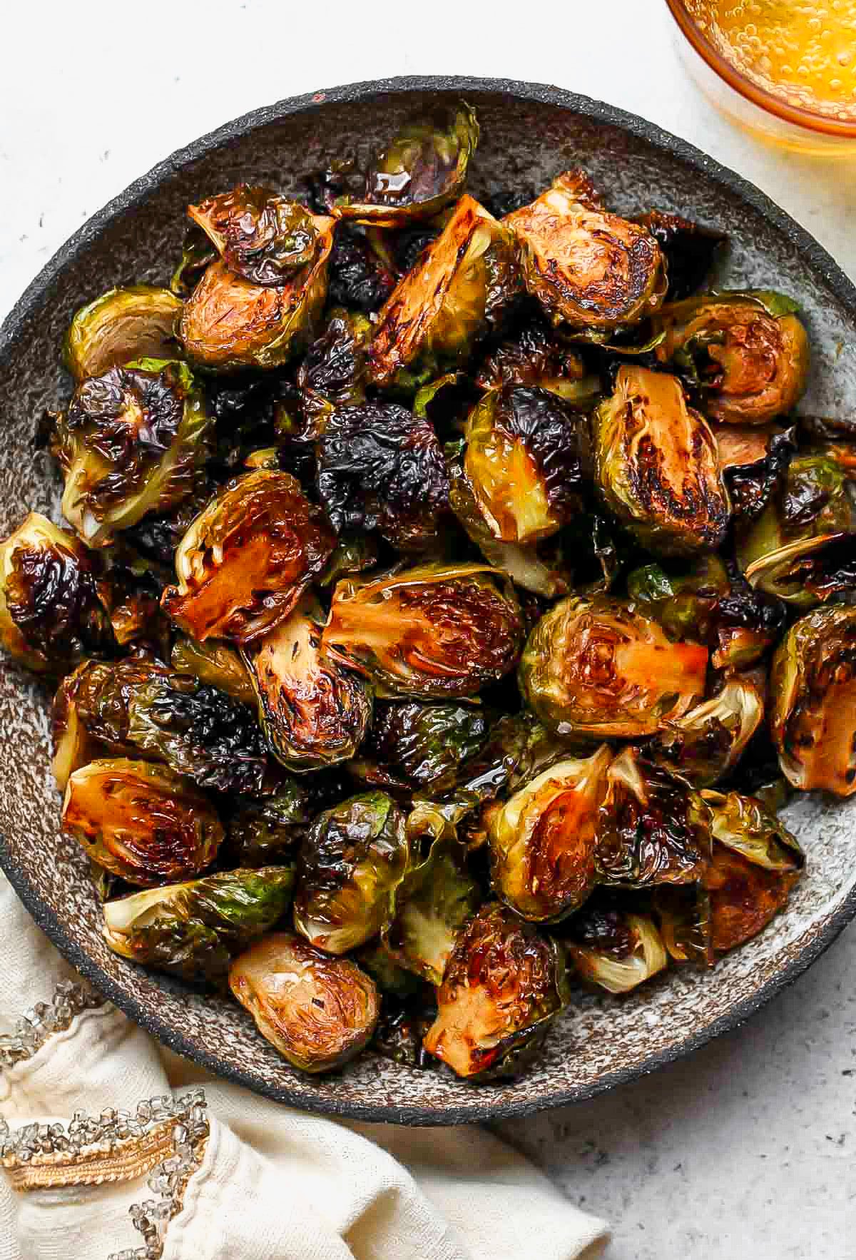 Chipotle-Balsamic Brussels Sprouts arranged in a grey serving bowl.