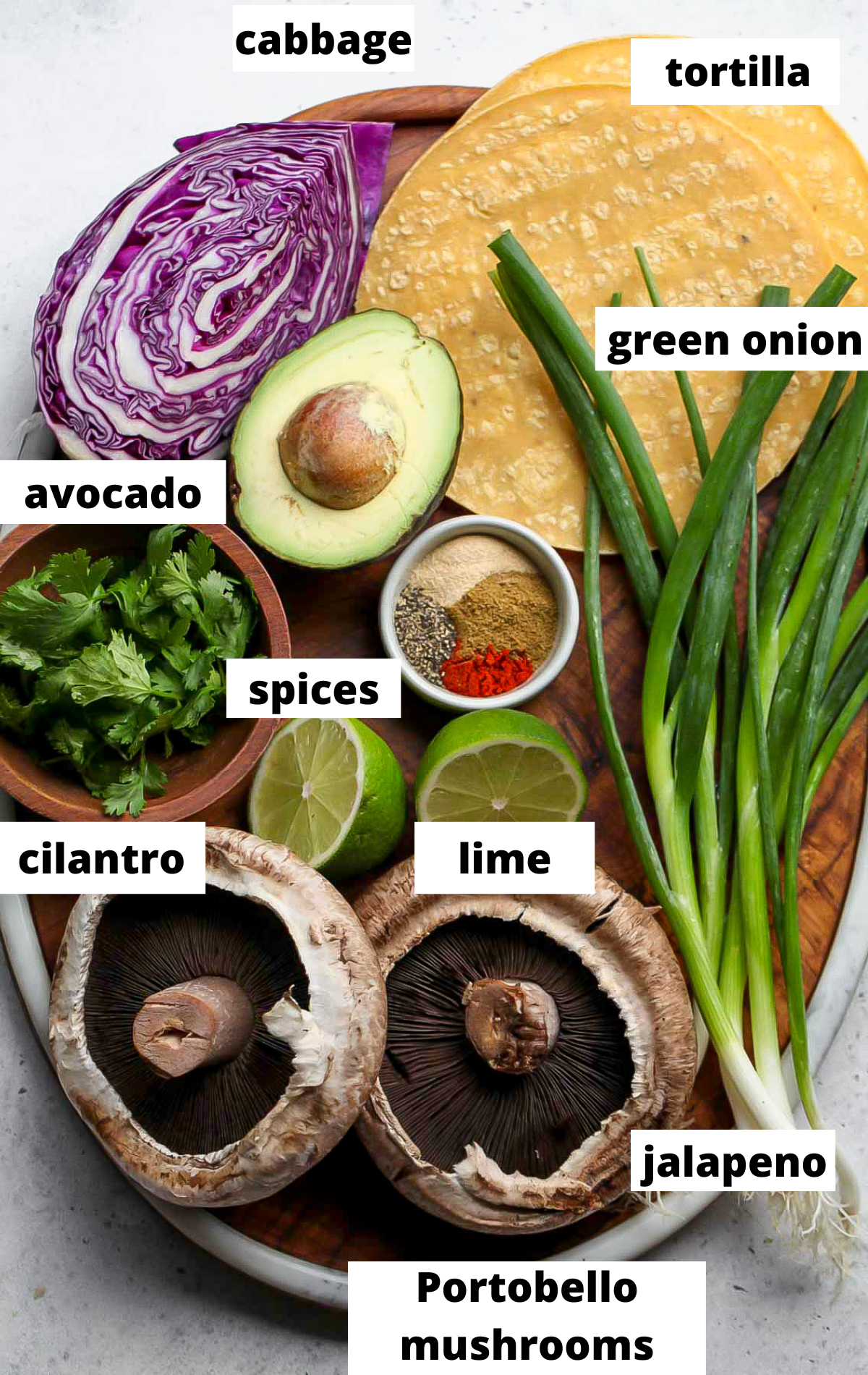 Recipe ingredients arranged on a wooden platter with labels.