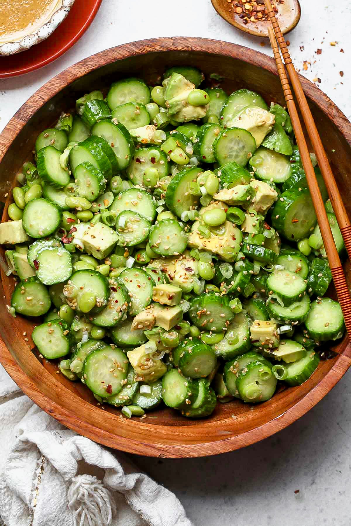 Cucumber-Edamame Salad with Sesame-Ginger Dressing in a large wooden serving bowl.