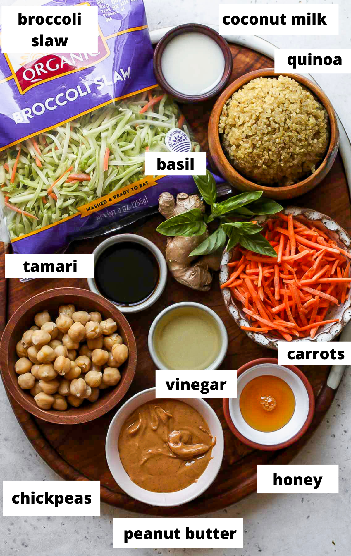 Recipe ingredients in separate bowls on a wooden serving platter with labels.