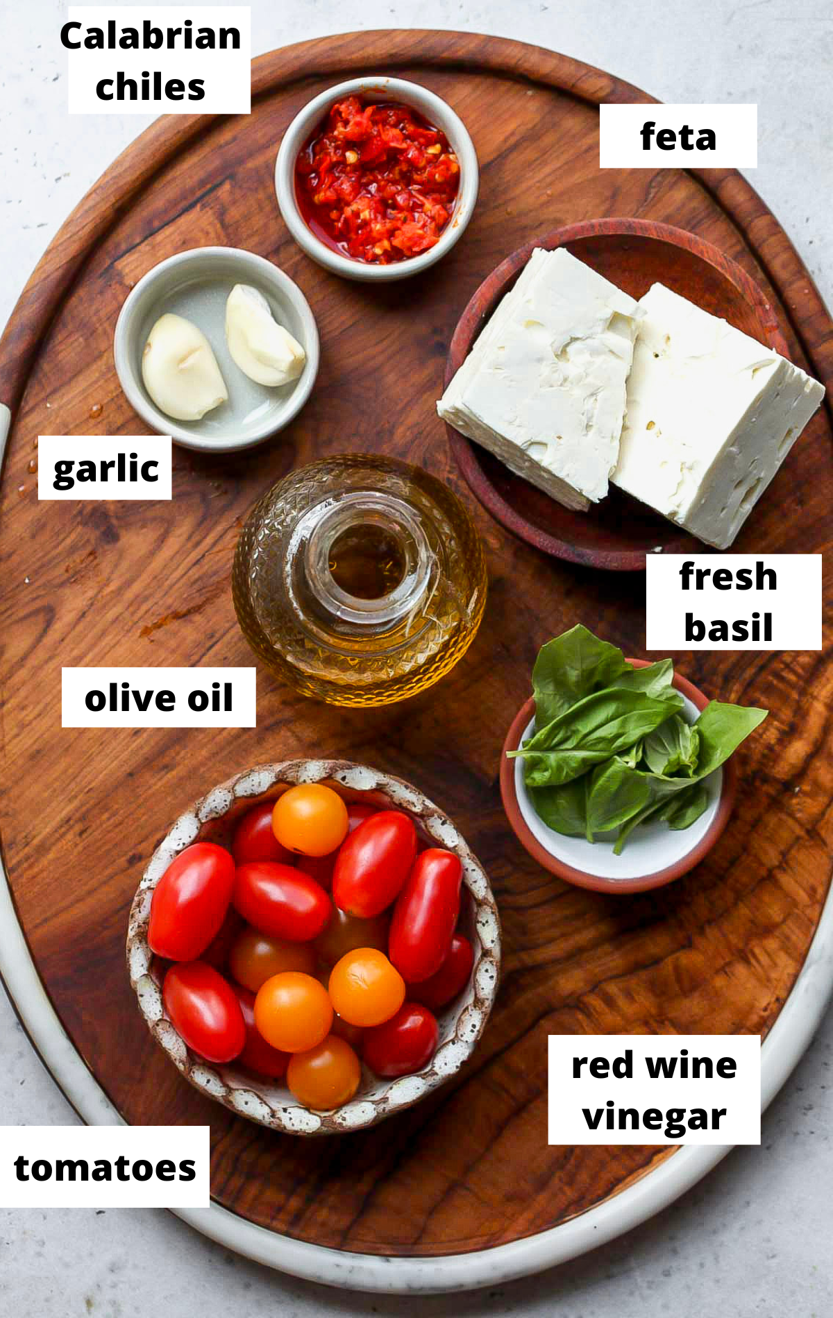 Recipe ingredients in separate bowls on a serving tray with labels.