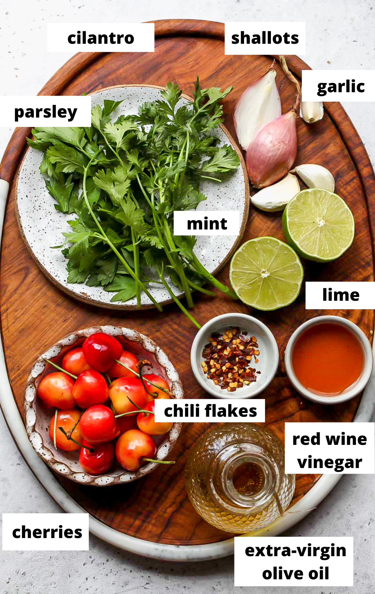 Recipe ingredients in separate bowls with labels on a wooden tray.
