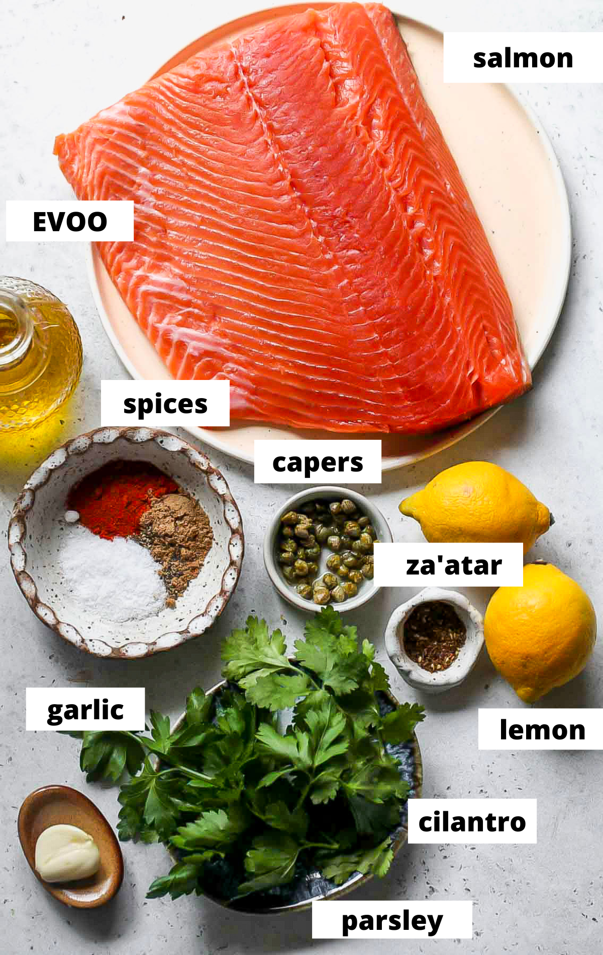 Recipe ingredients arranged on a wooden platter with labels.