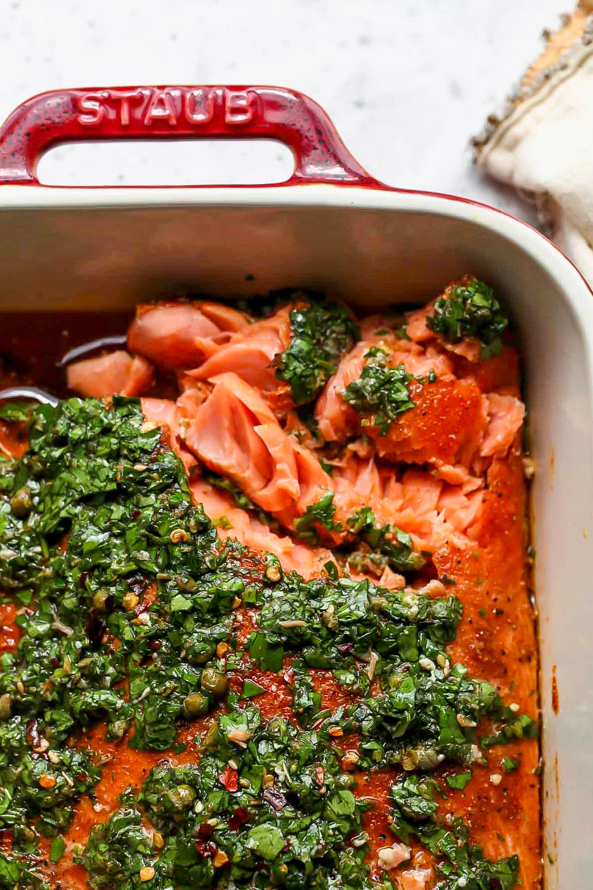 Salmon being flaked with a fork to show inside texture.