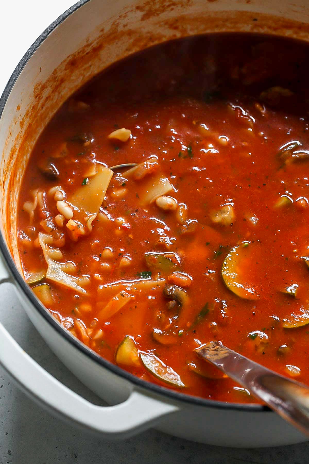 Soup shown after being finished simmering in a large white post.