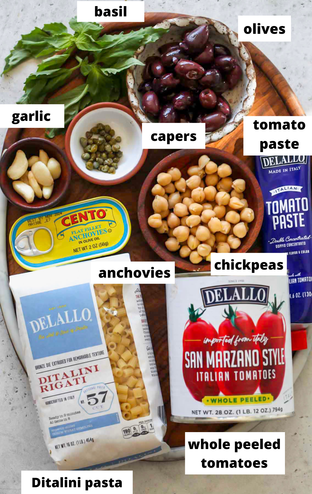 Recipe ingredients arranged on a wooden board with labels.