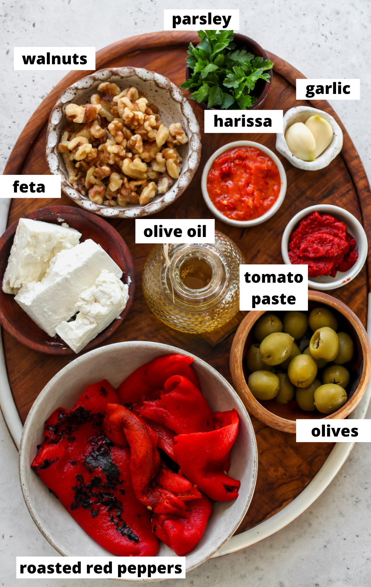 Recipe ingredients in separate bowls on a wooden board with labels.