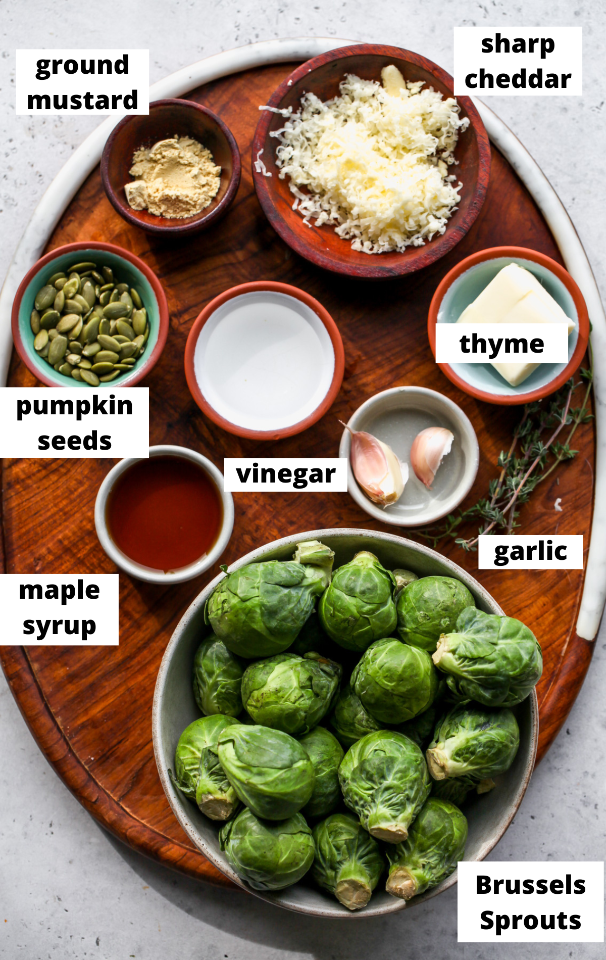 Recipe ingredients in separate bowls arranged on a wooden board.