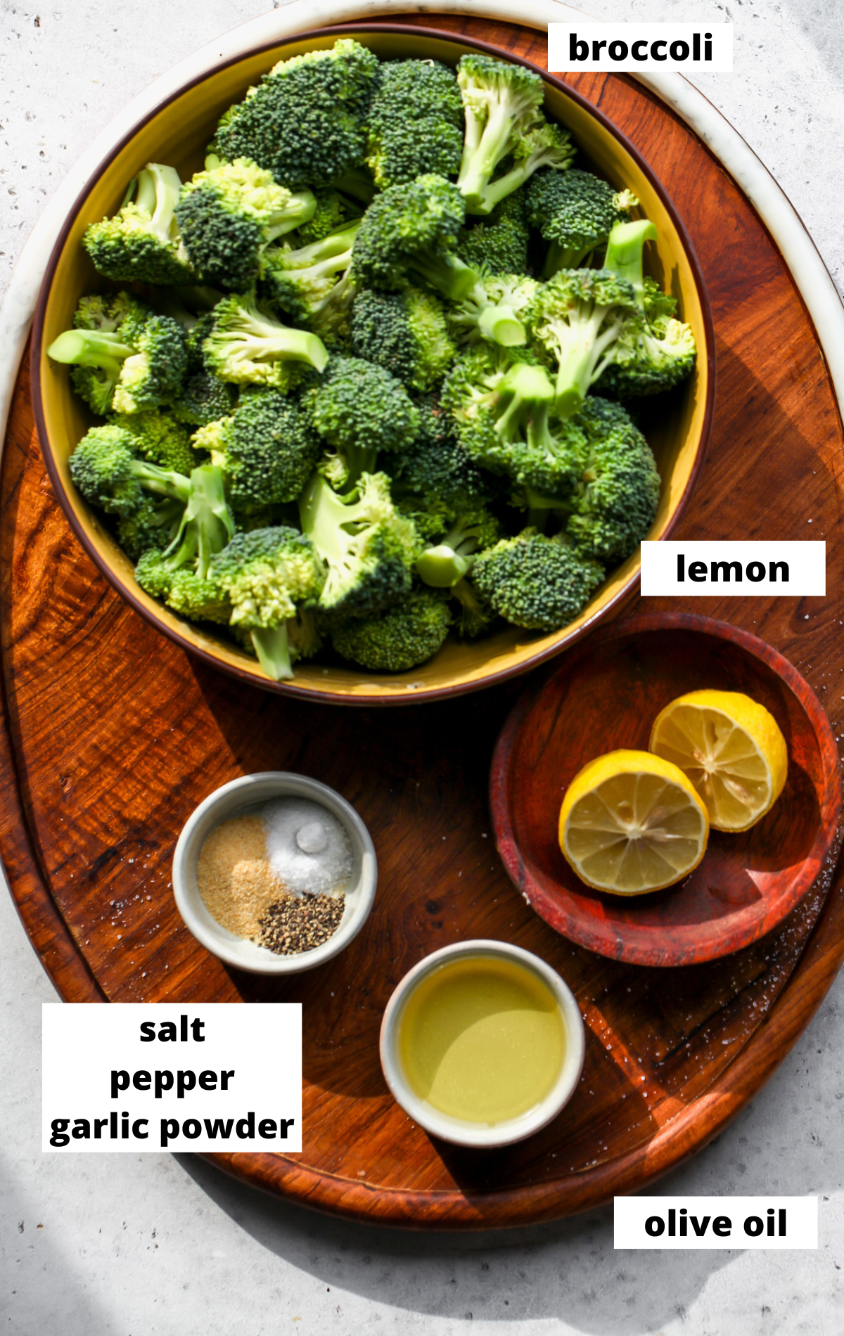 Recipe ingredients in separate bowls arranged on a wooden board with labels.