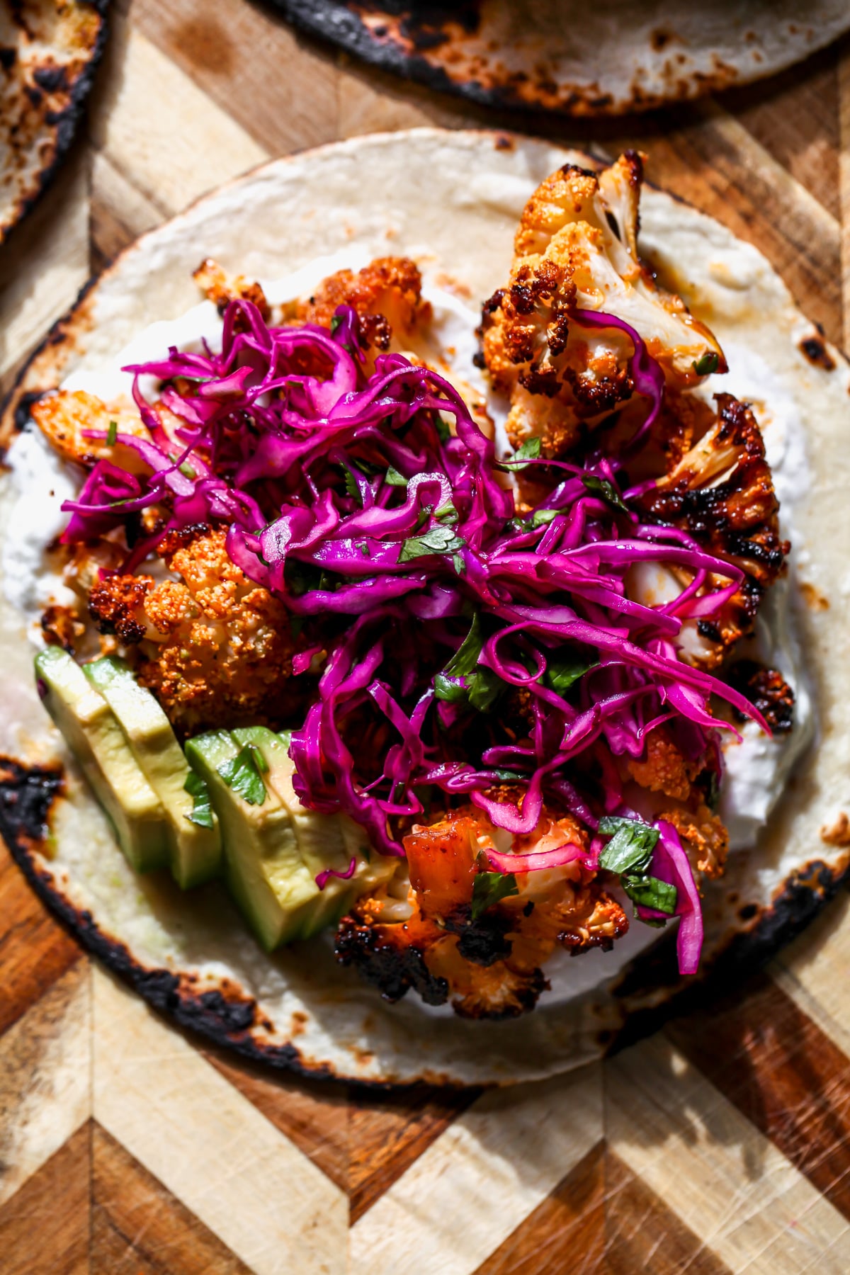 A tortilla topped with garlic aioli, chipotle-roasted cauliflower, and slaw.