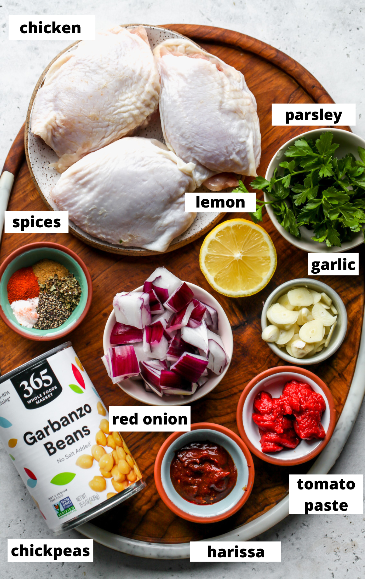 Recipe ingredients arranged on a wooden board with labels.