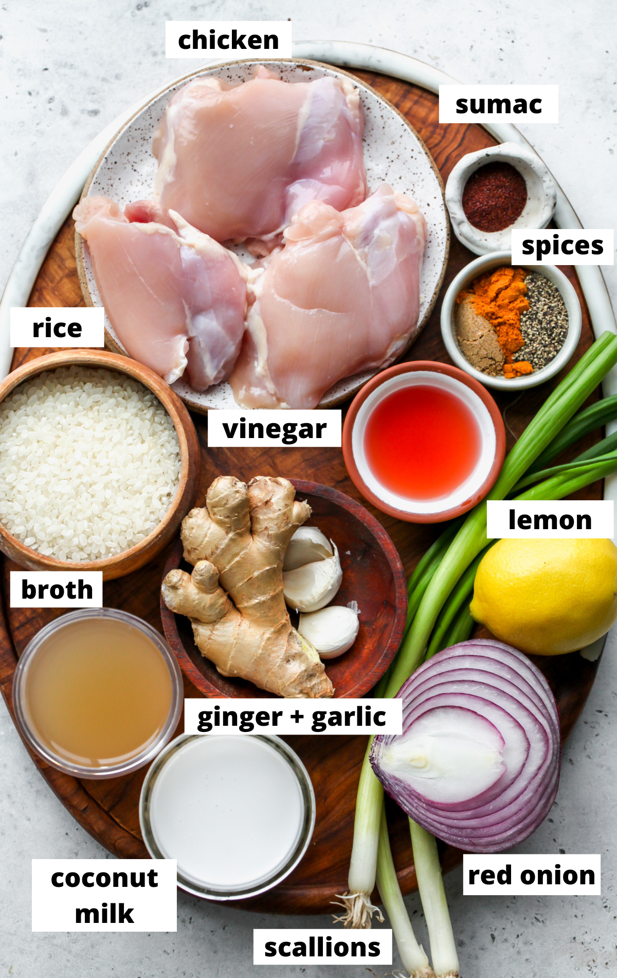 Recipe ingredients arranged on a wooden board with labels.